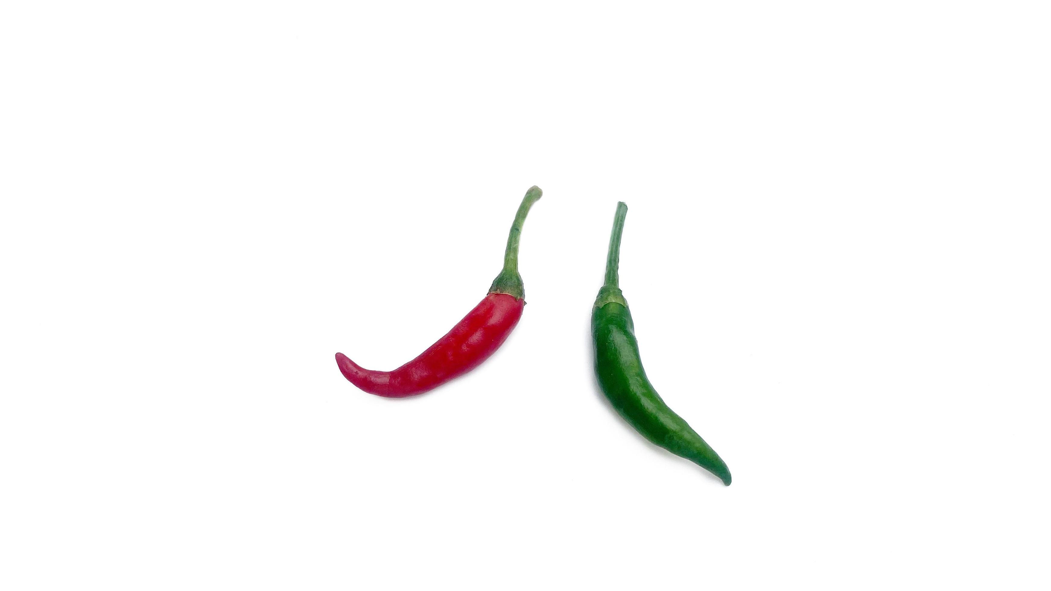 
									Fresh red and green chili peppers placed on a white background, great for editing and advertising spicy foods. Stock Free