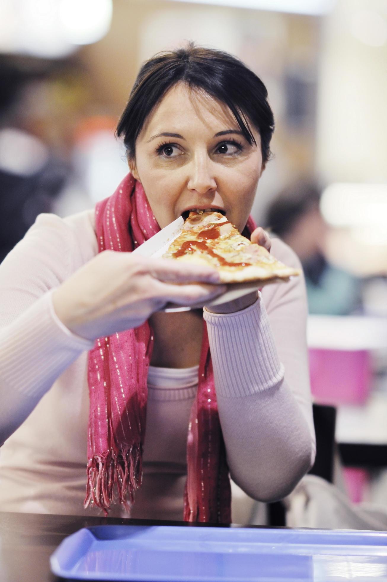 woman eat pizza food at restaurant Stock Free