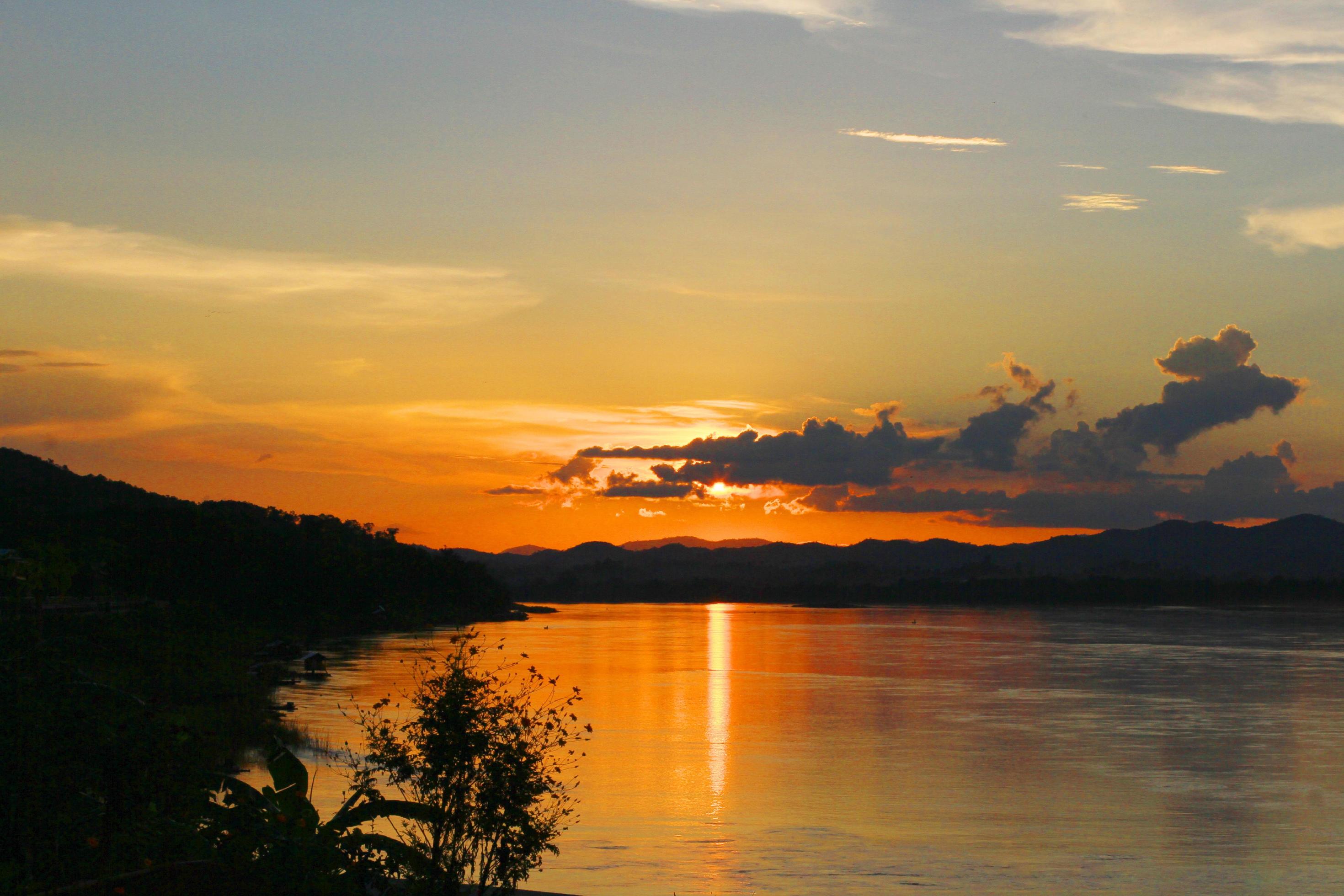 Tradition of Long tail boat and fisherman in beautiful sunset twilight at Khong river the Thai-Laos border Chaingkhan distric Thailand Stock Free