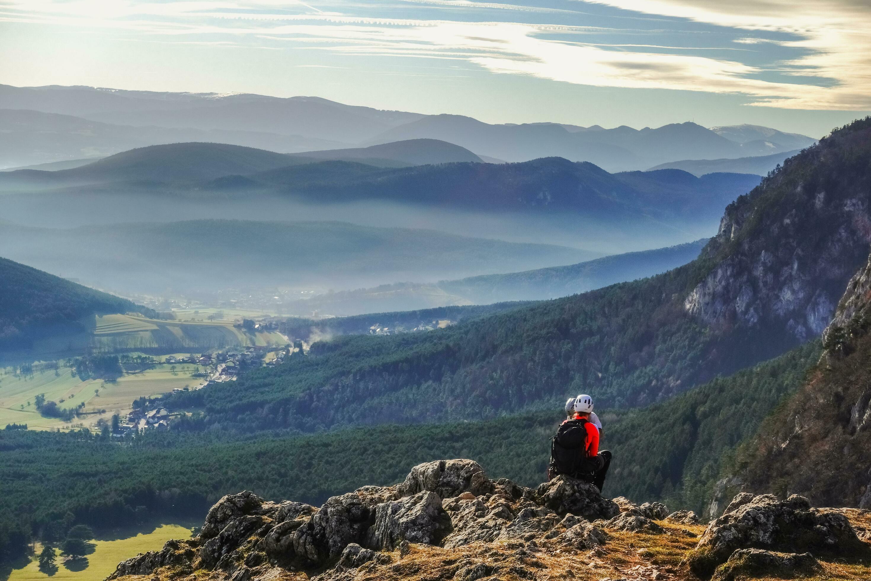 two colorful climber sitting on a rock after the tour Stock Free