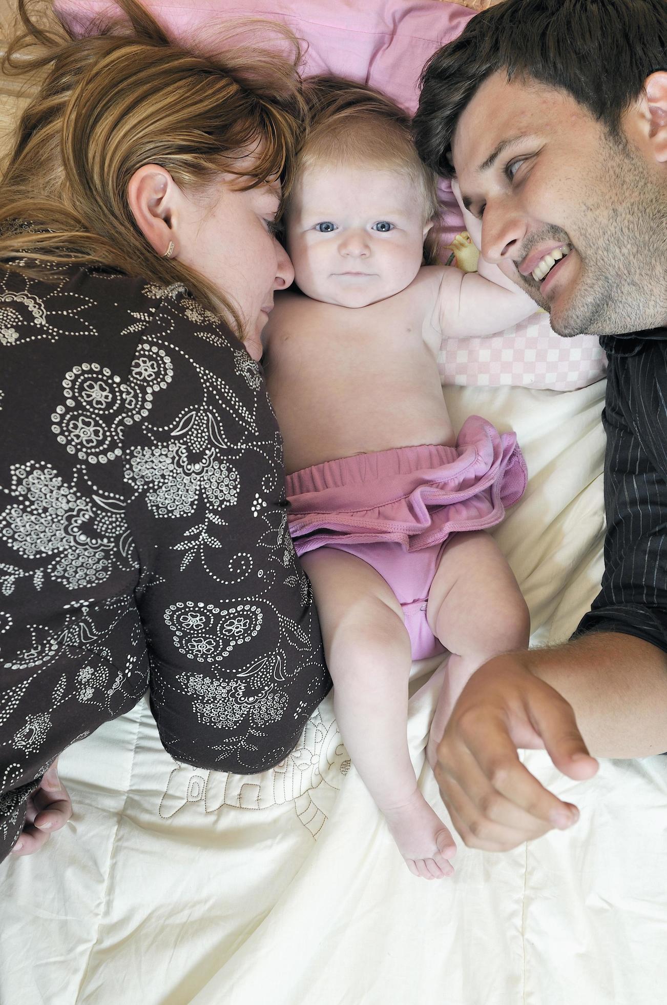 portrait of young family with cute little babby Stock Free