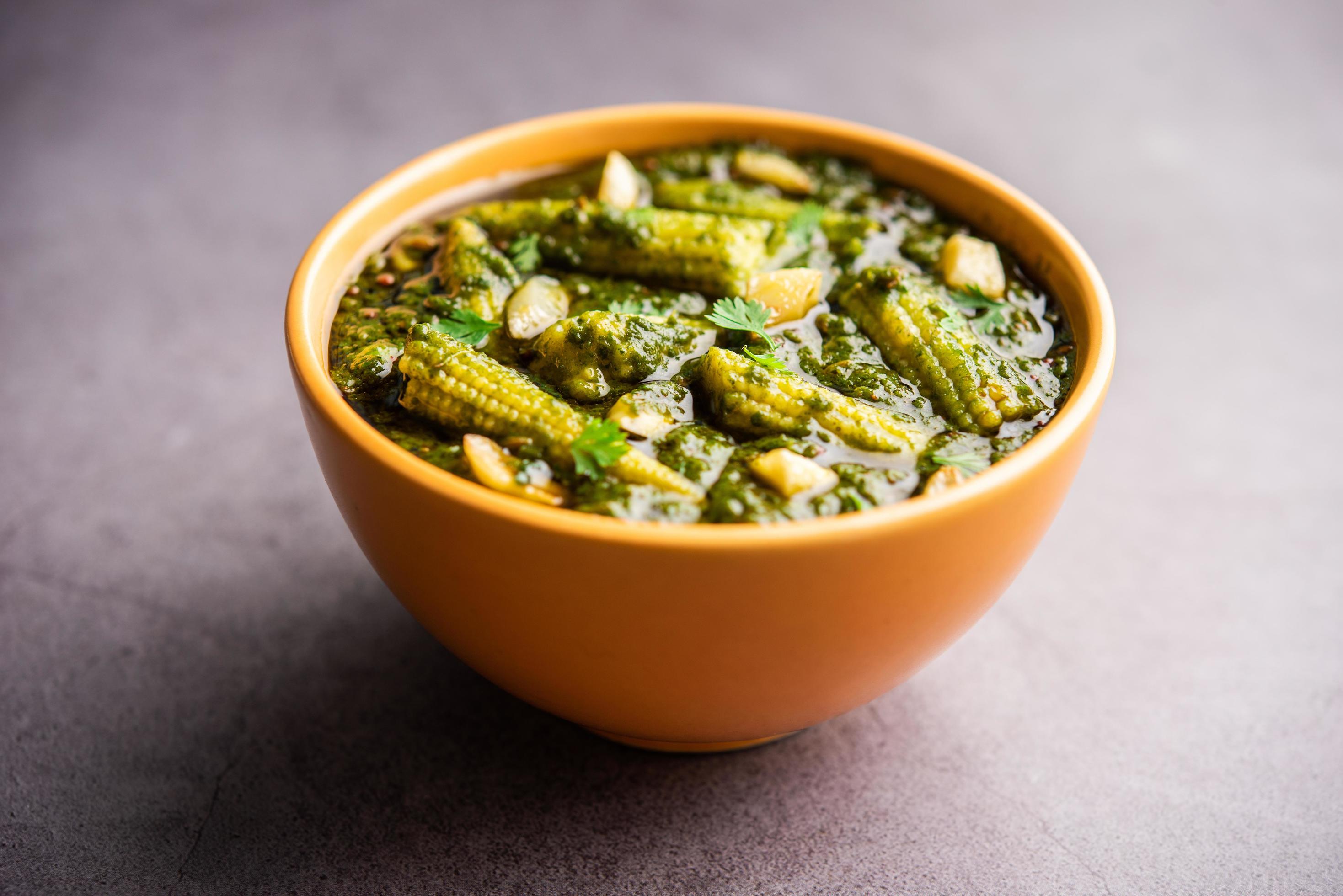 palak baby corn sabzi also known as spinach makai curry served with rice or roti, Indian food Stock Free