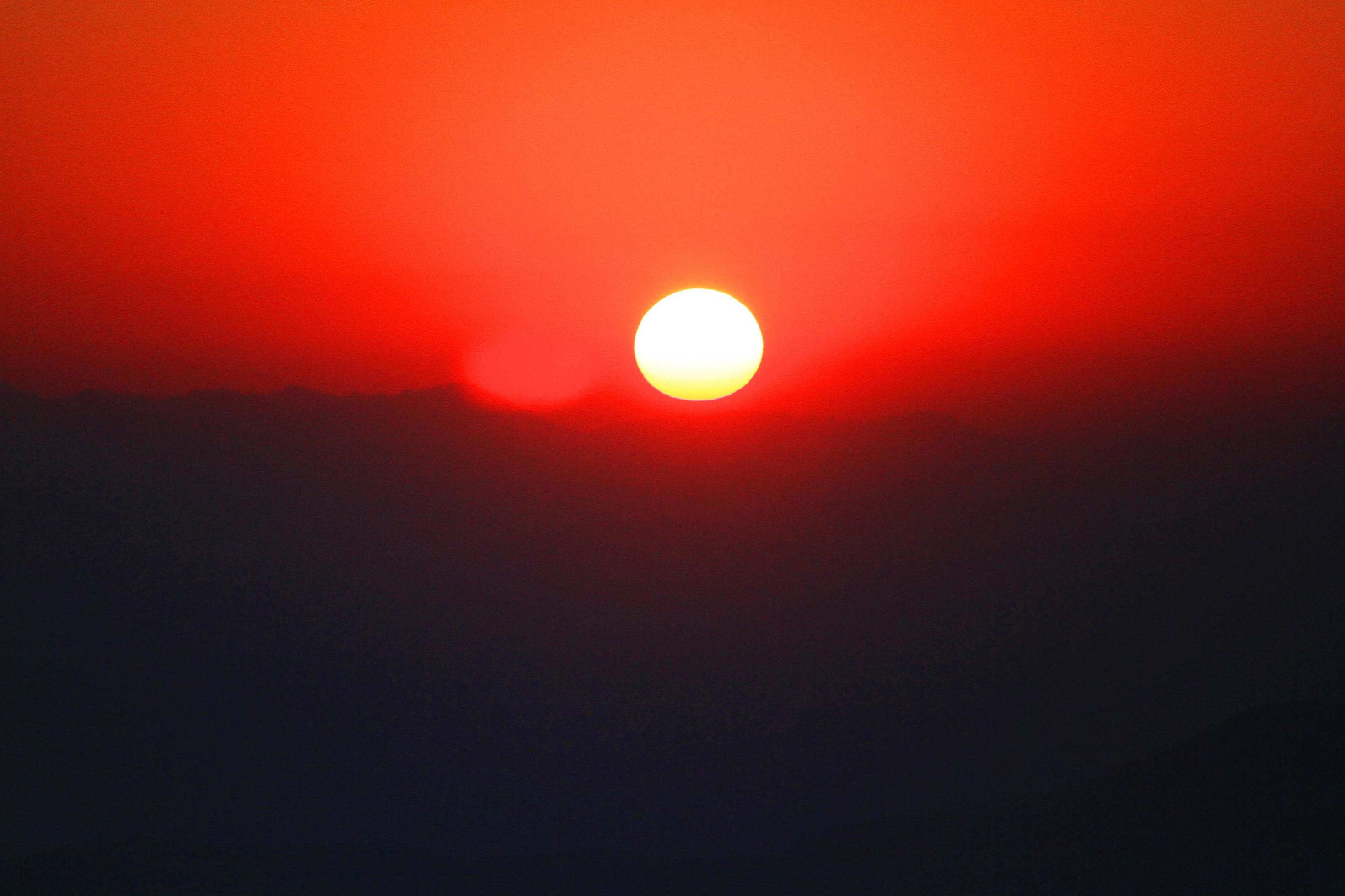 Sunset in sky and cloud, beautiful colorful twilight time with silhouette of mountain. Stock Free