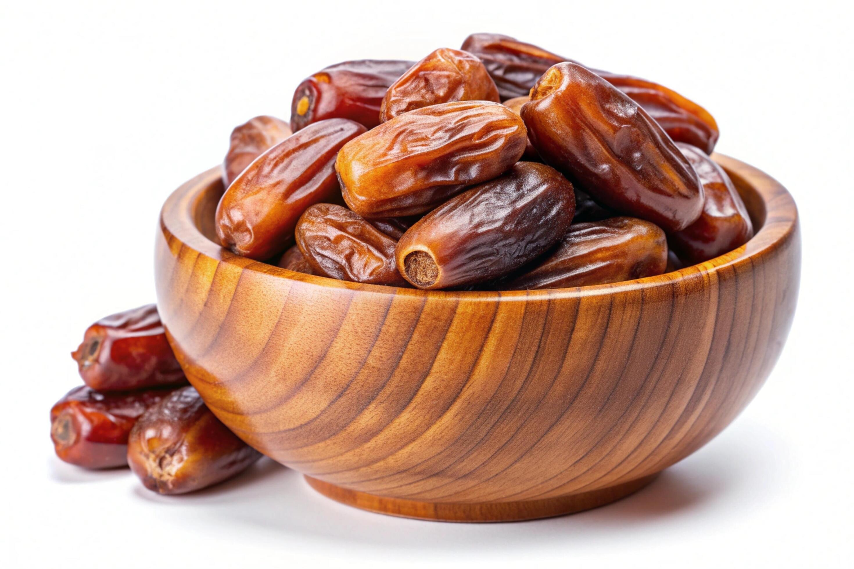 Dates in wood bowl isolated on white background Stock Free