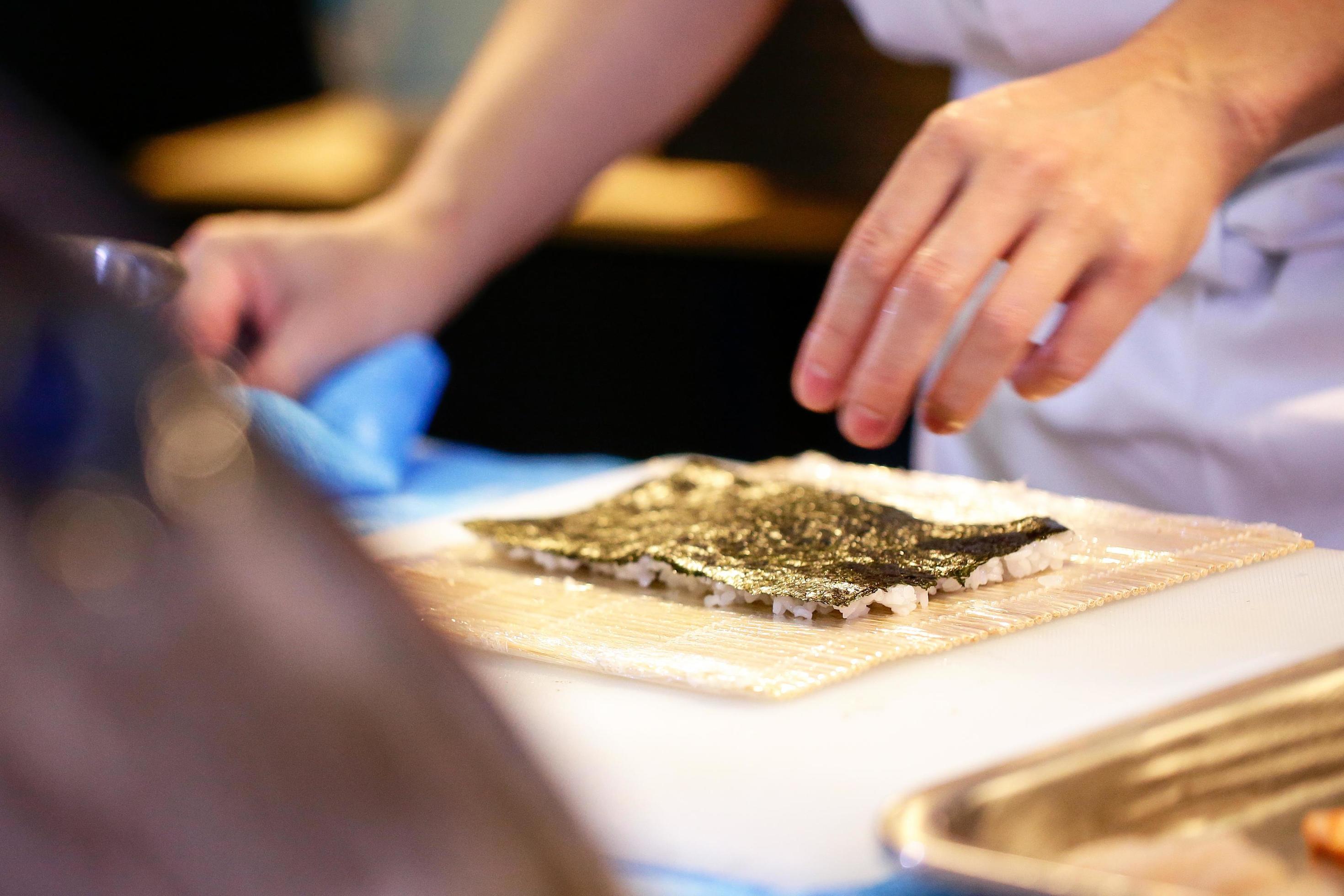 chef hands preparing japanese food, chef making sushi Stock Free