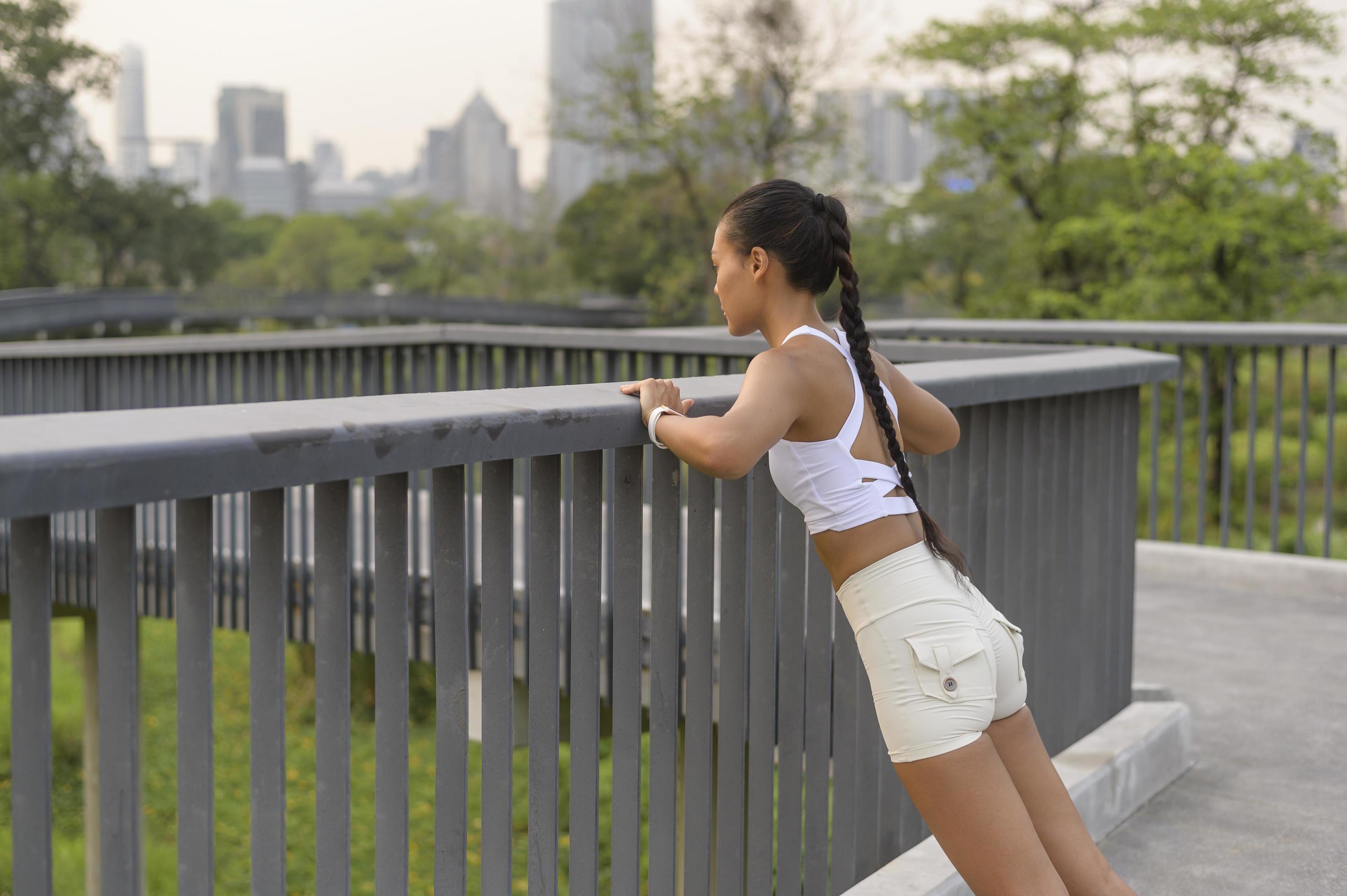 A young fitness woman in sportswear exercising in city park, Healthy and Lifestyles. Stock Free