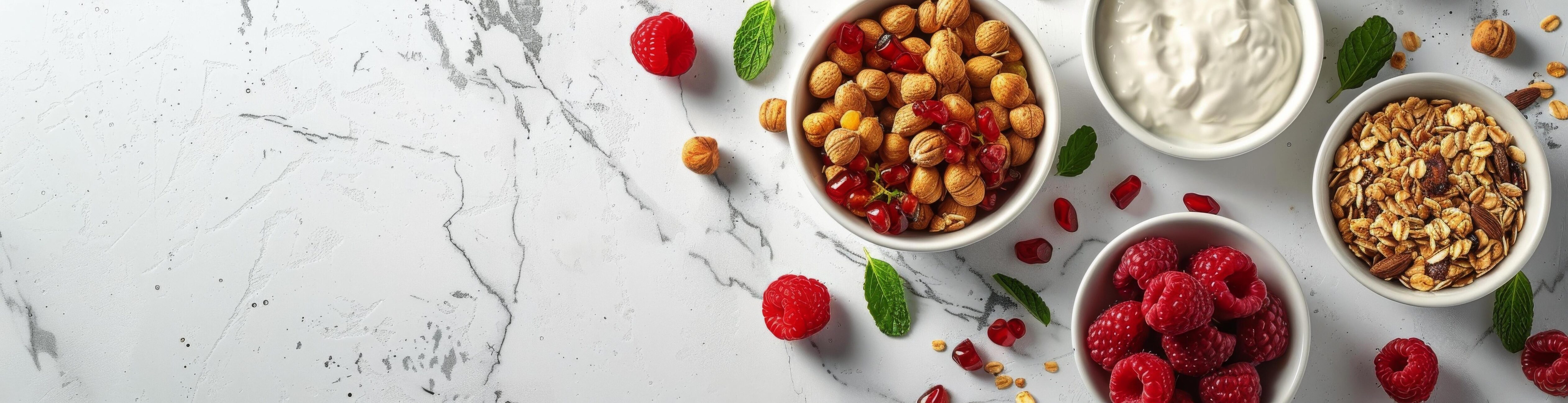 White Marble Surface With Bowls of Yogurt, Granola, and Raspberries Stock Free