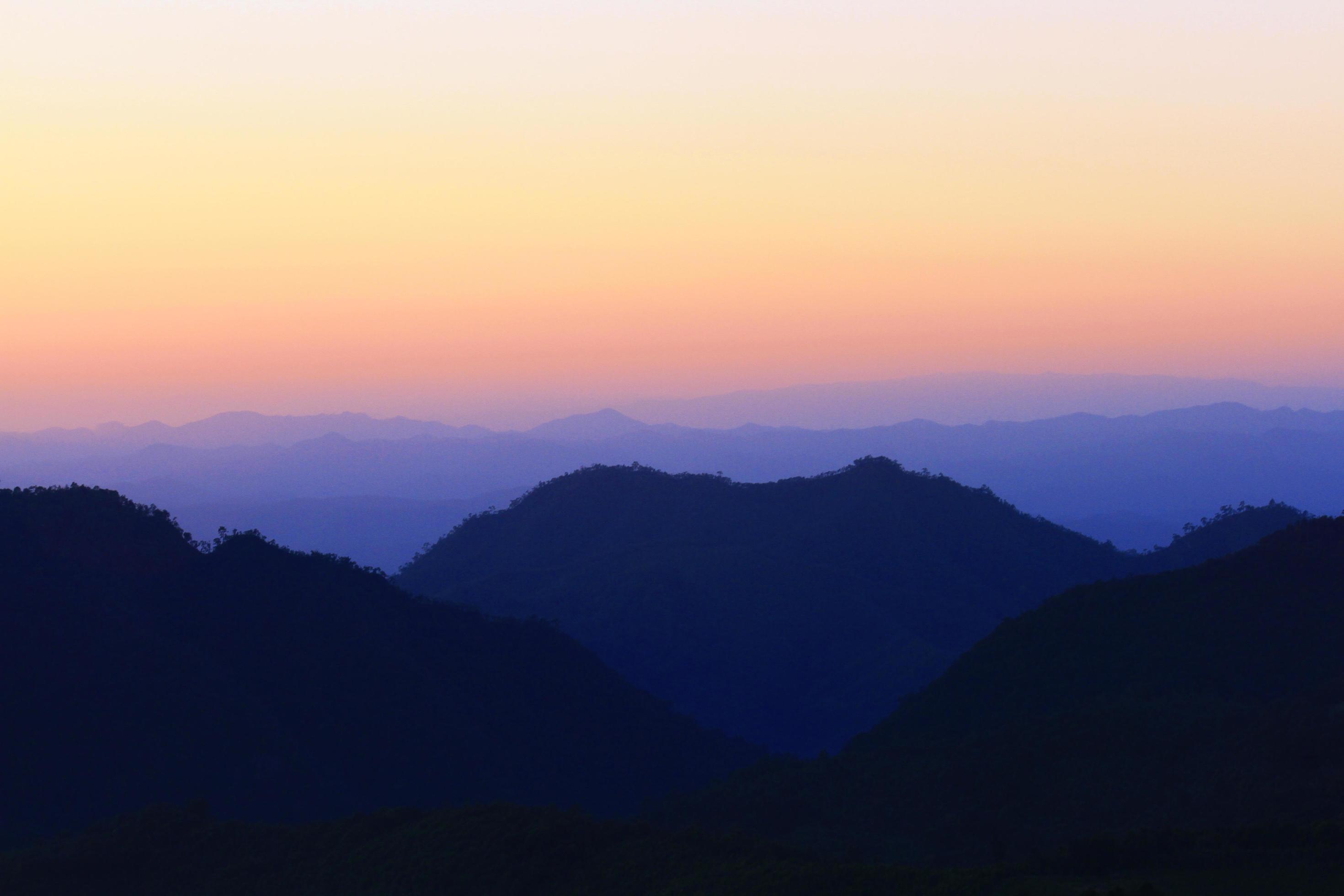 Sunset in sky and cloud, beautiful colorful twilight time with silhouette of mountain. Stock Free