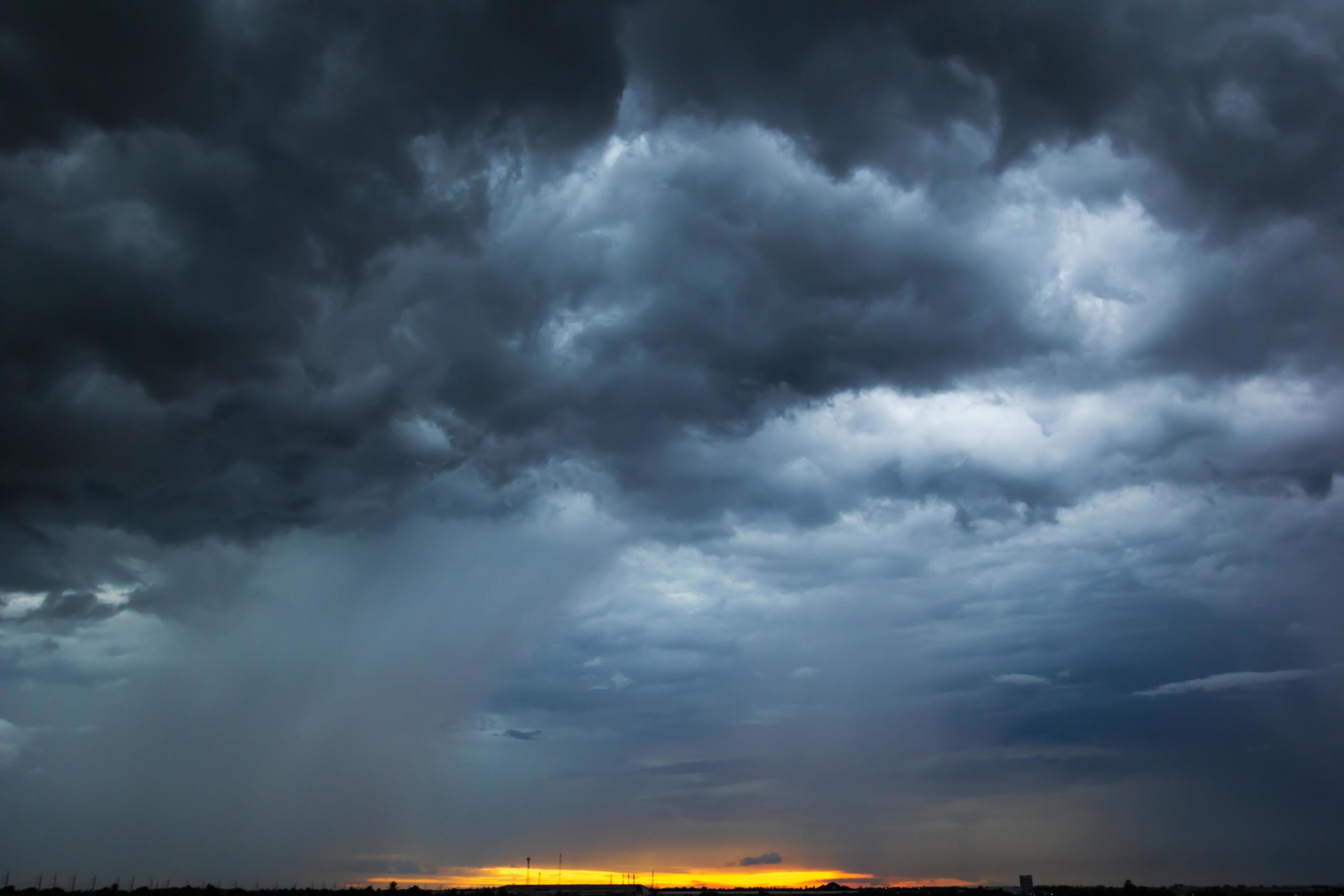 The dark sky had clouds gathered to the left and a strong storm before it rained. Stock Free