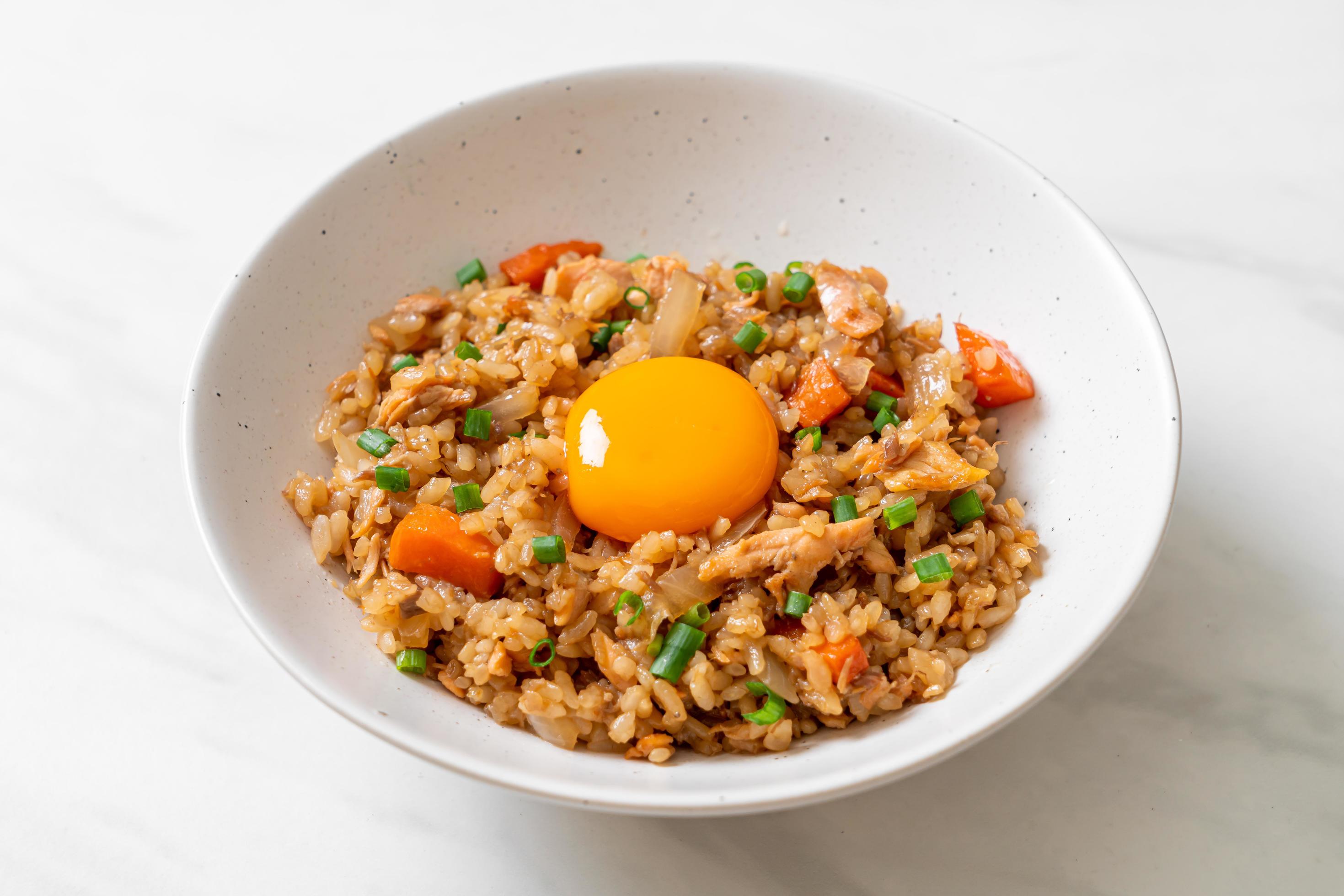 Salmon fried rice with pickled egg on top – Asian food style Stock Free