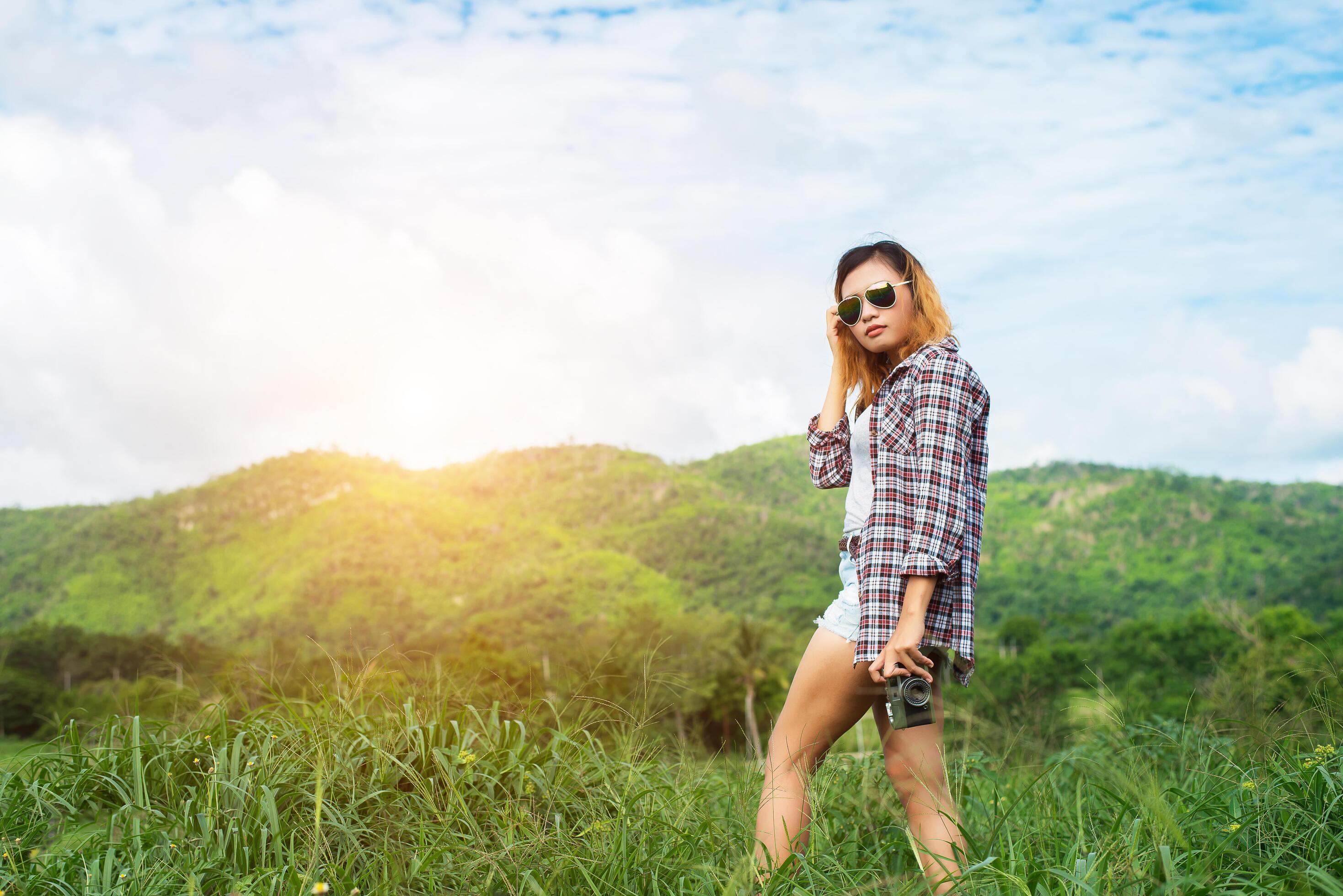 Young Hipster Woman with retro camera taking shot outdoor landscape ,Lifestyle mountain nature on background. Stock Free