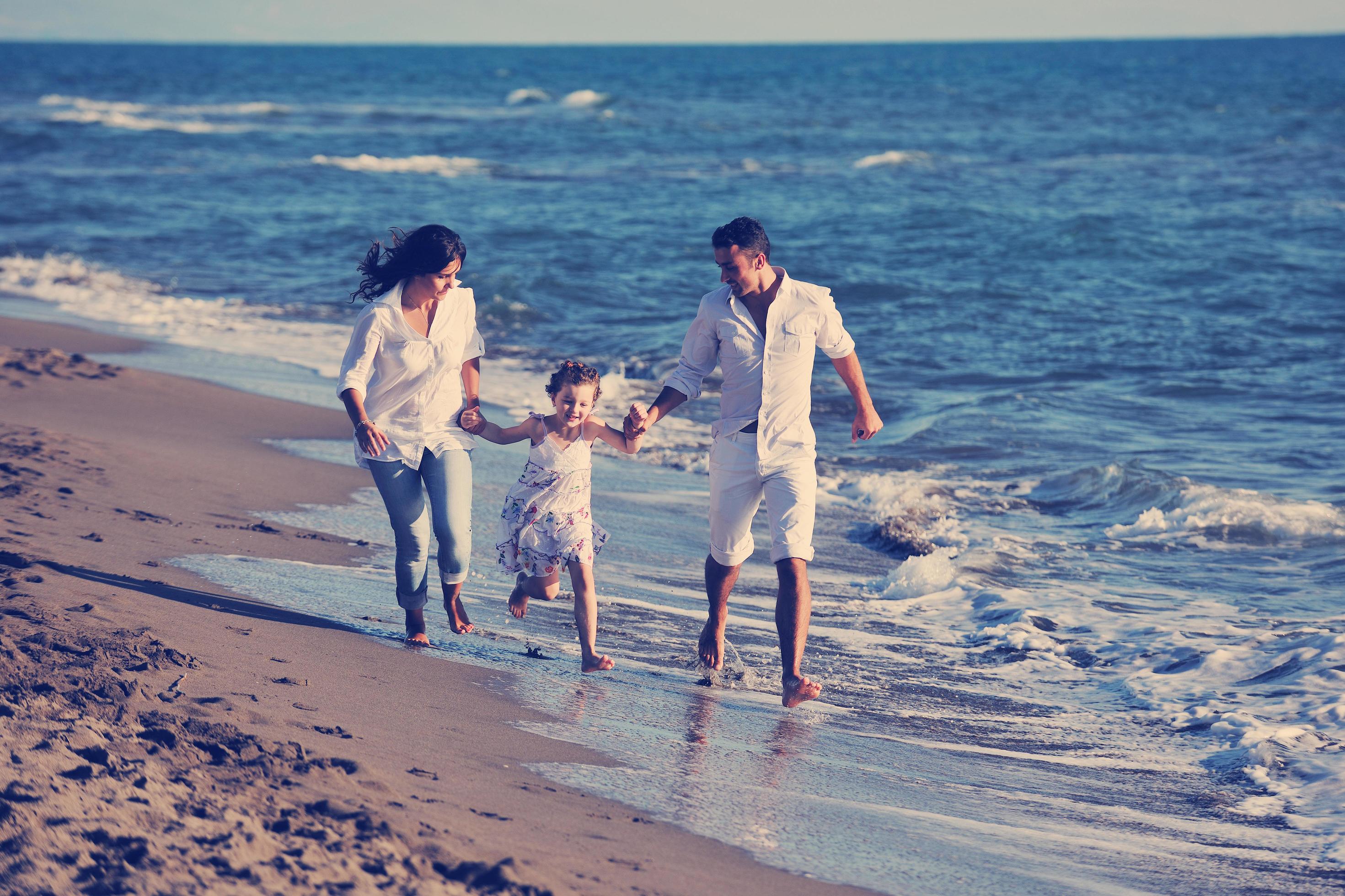 happy young family have fun on beach Stock Free