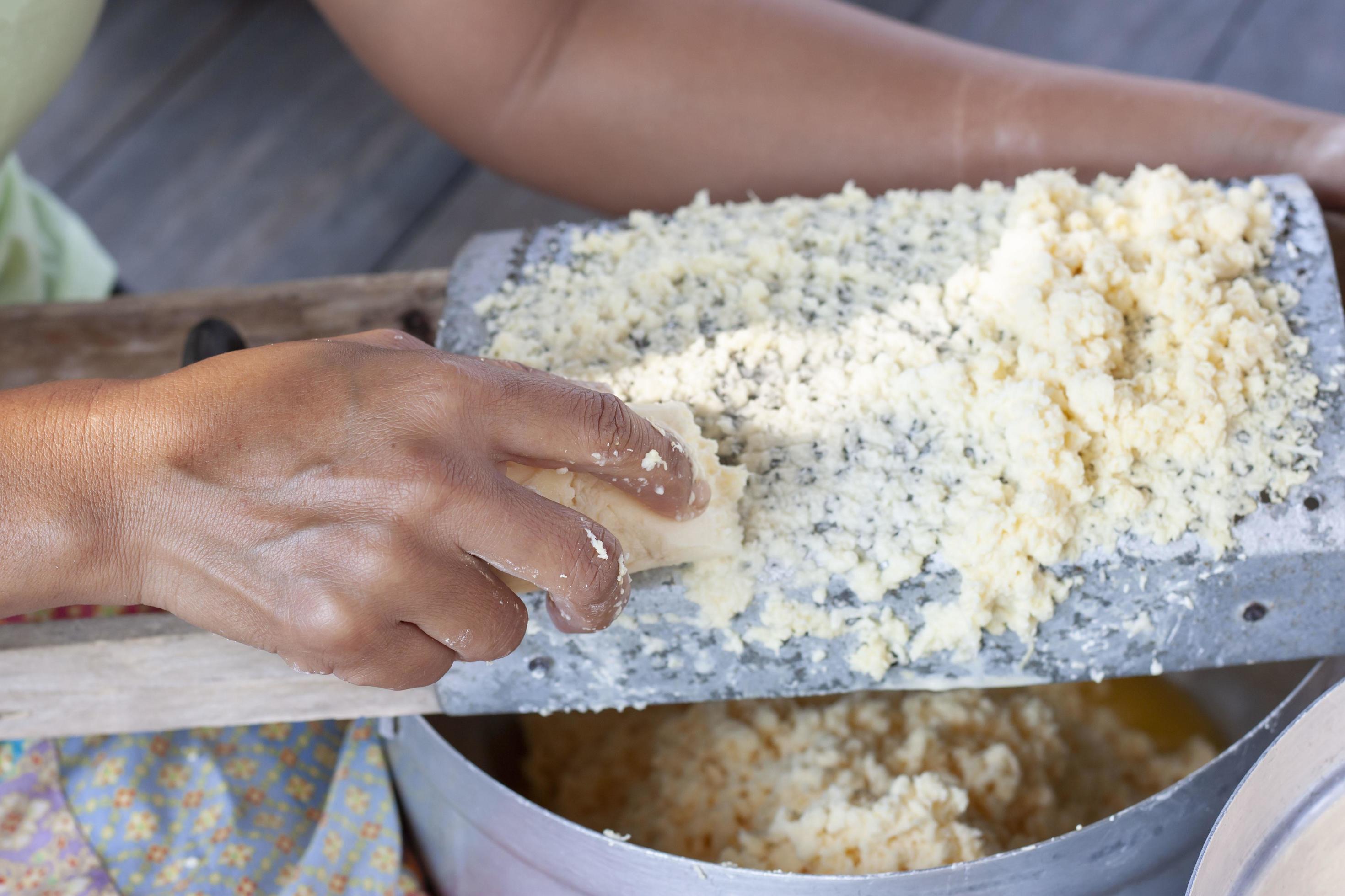 Hand of women scratching a potato for cooking food. Stock Free