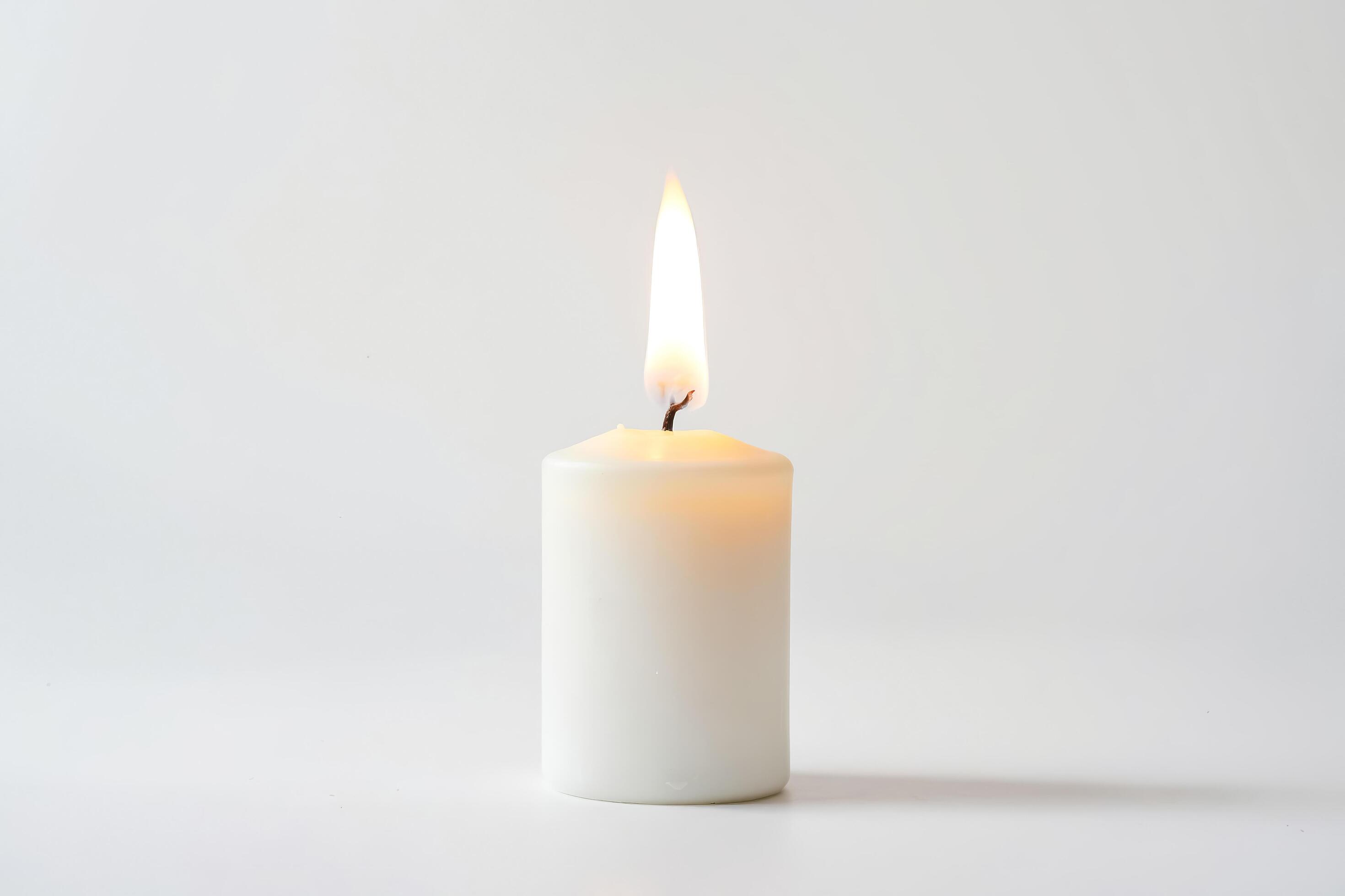 Single Burning Candle on a White Background Stock Free