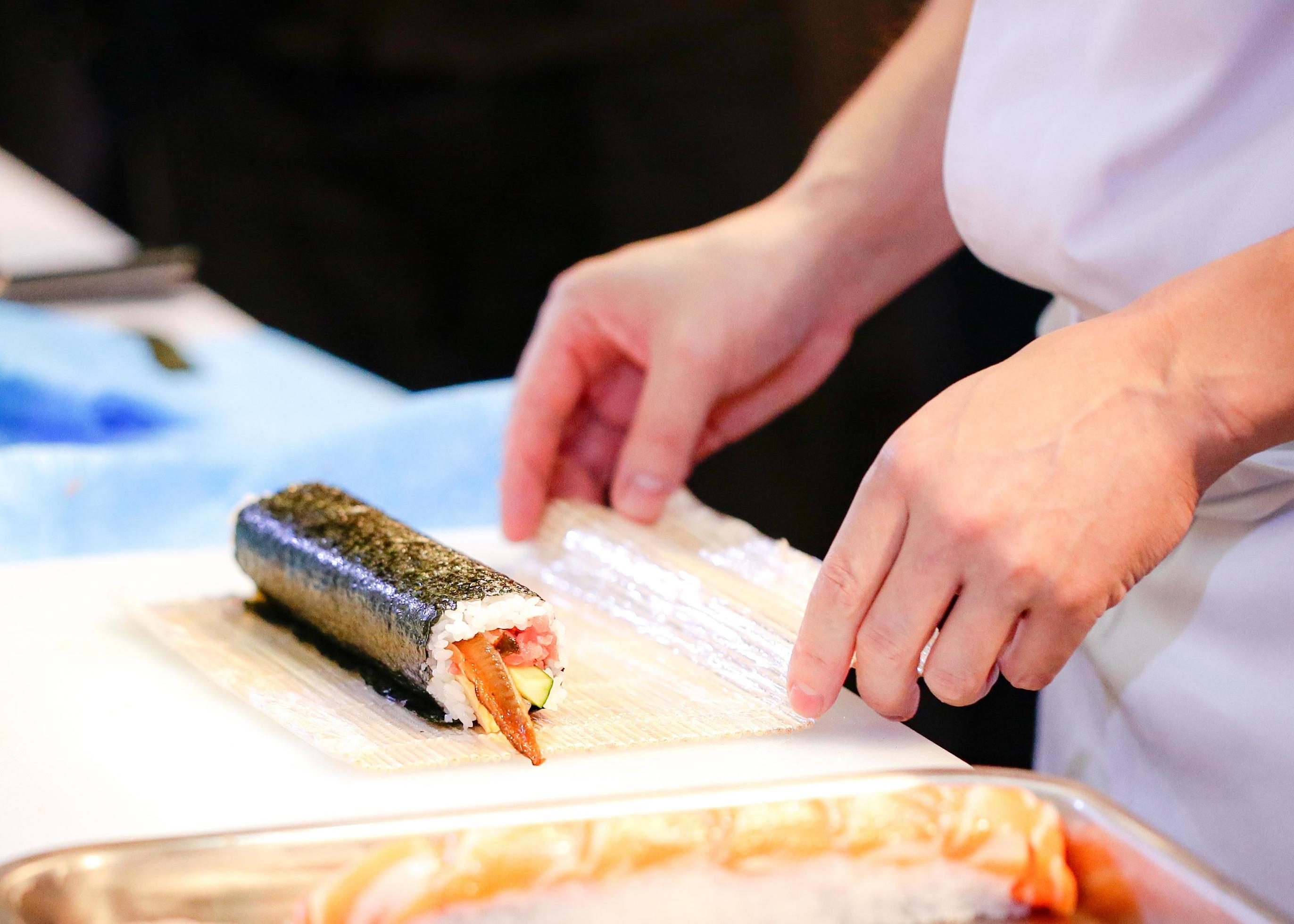 chef hands preparing japanese food, chef making sushi Stock Free