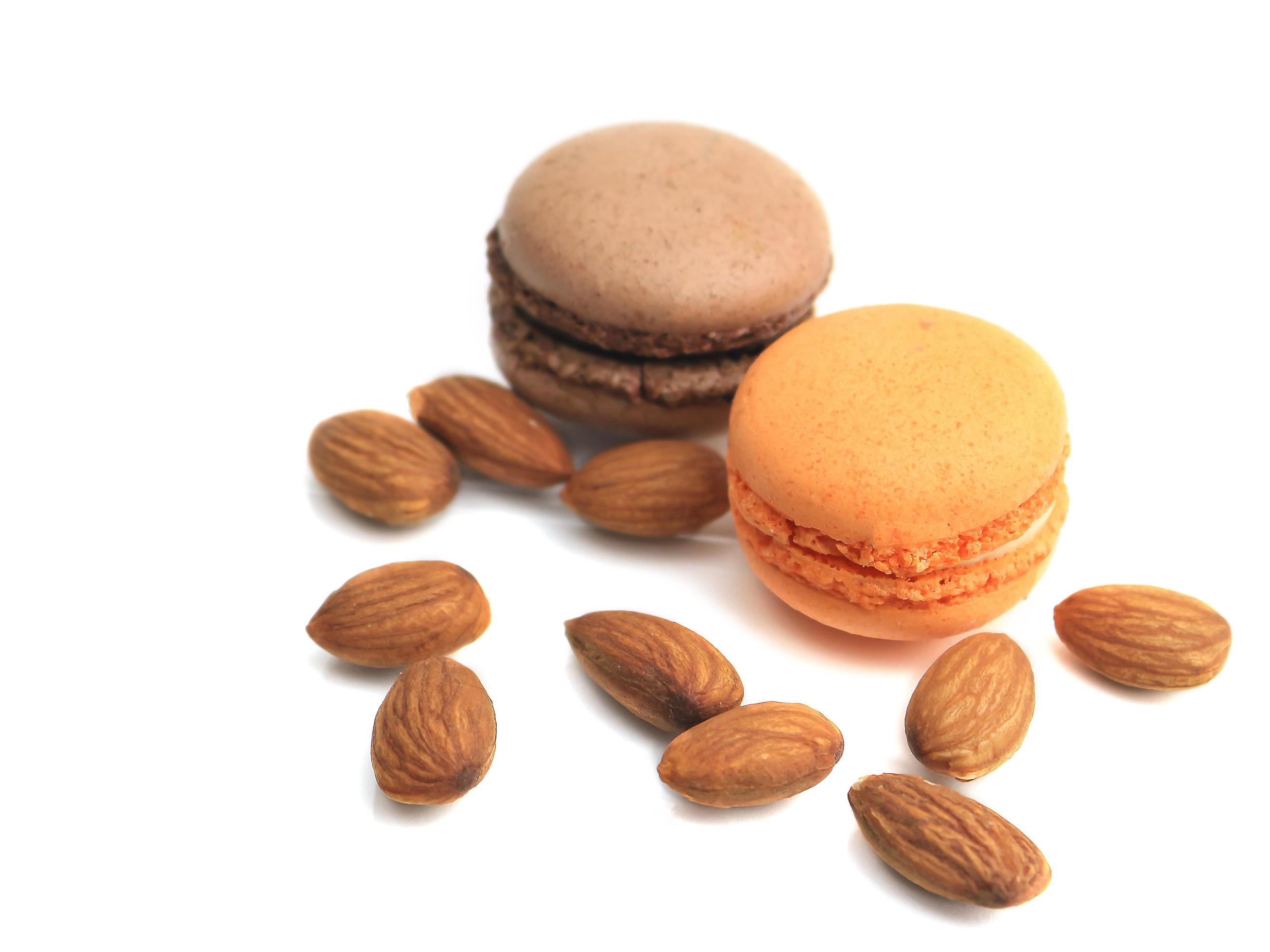 French macarons macaroons cake with almond nut seed on white background, delicious sweet dessert food background concept. Stock Free