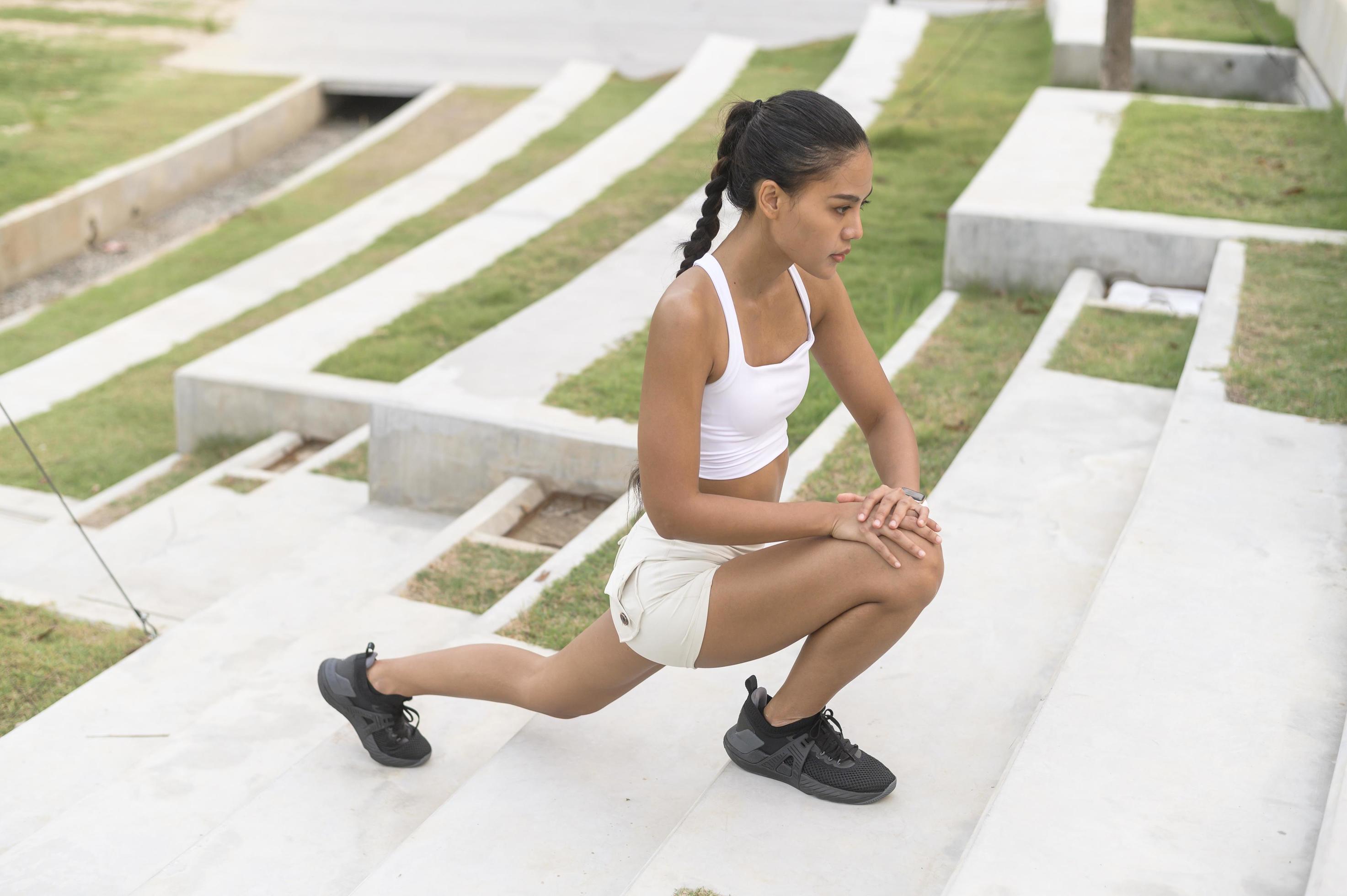 A young fitness woman in sportswear exercising in city park, Healthy and Lifestyles. Stock Free