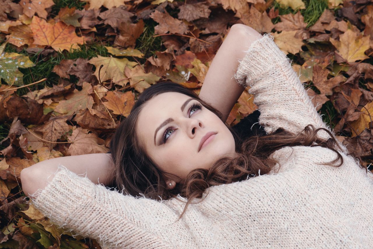 Beautiful Girl Portrait Lying on the Autumn Leaves in the Park Stock Free