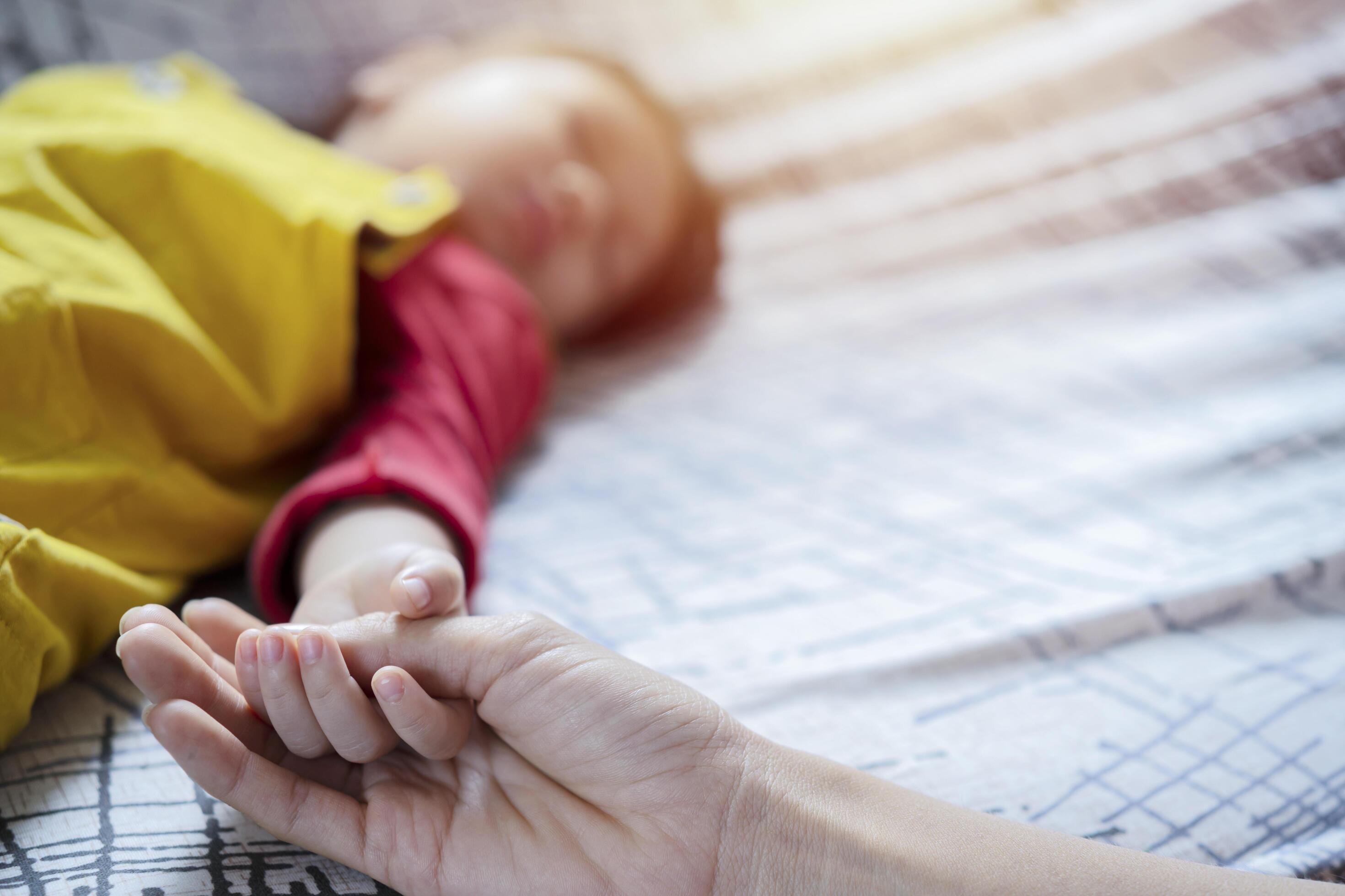 Hand the sleeping baby in the hand of mother close up, New family and baby protection from mom concept Stock Free