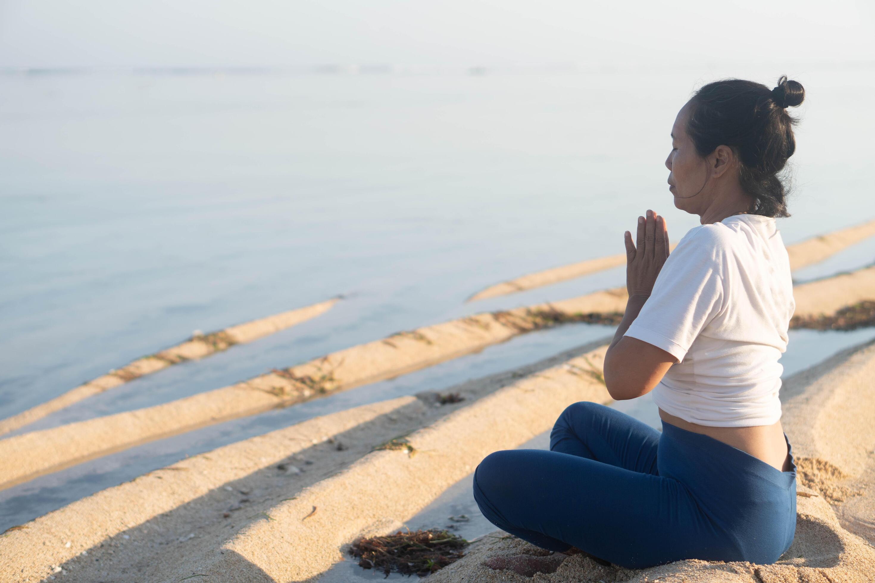 healthy woman with beautiful body doing yoga at sunrise on the beach, yoga poses Stock Free