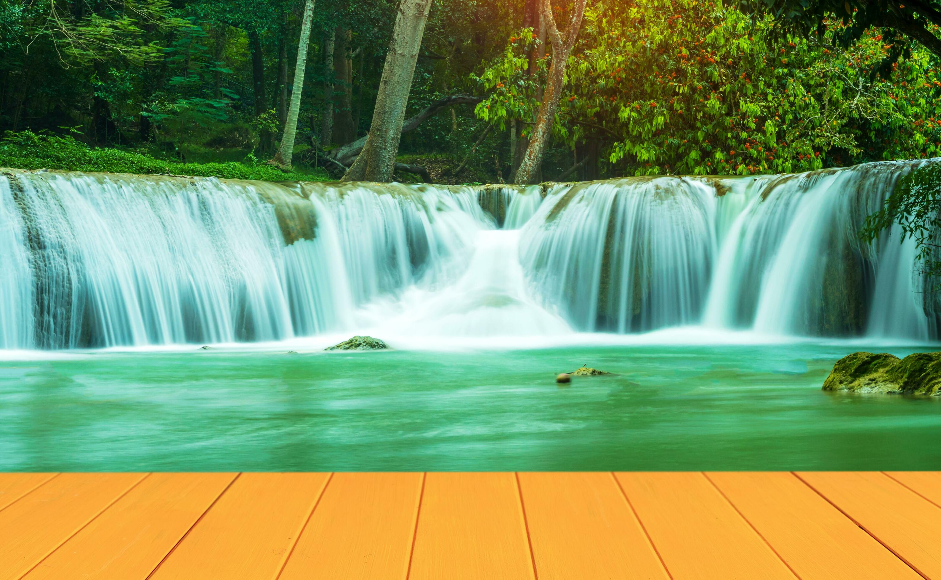 Natural wood floors and a beautiful waterfall in the middle of the forest. Stock Free