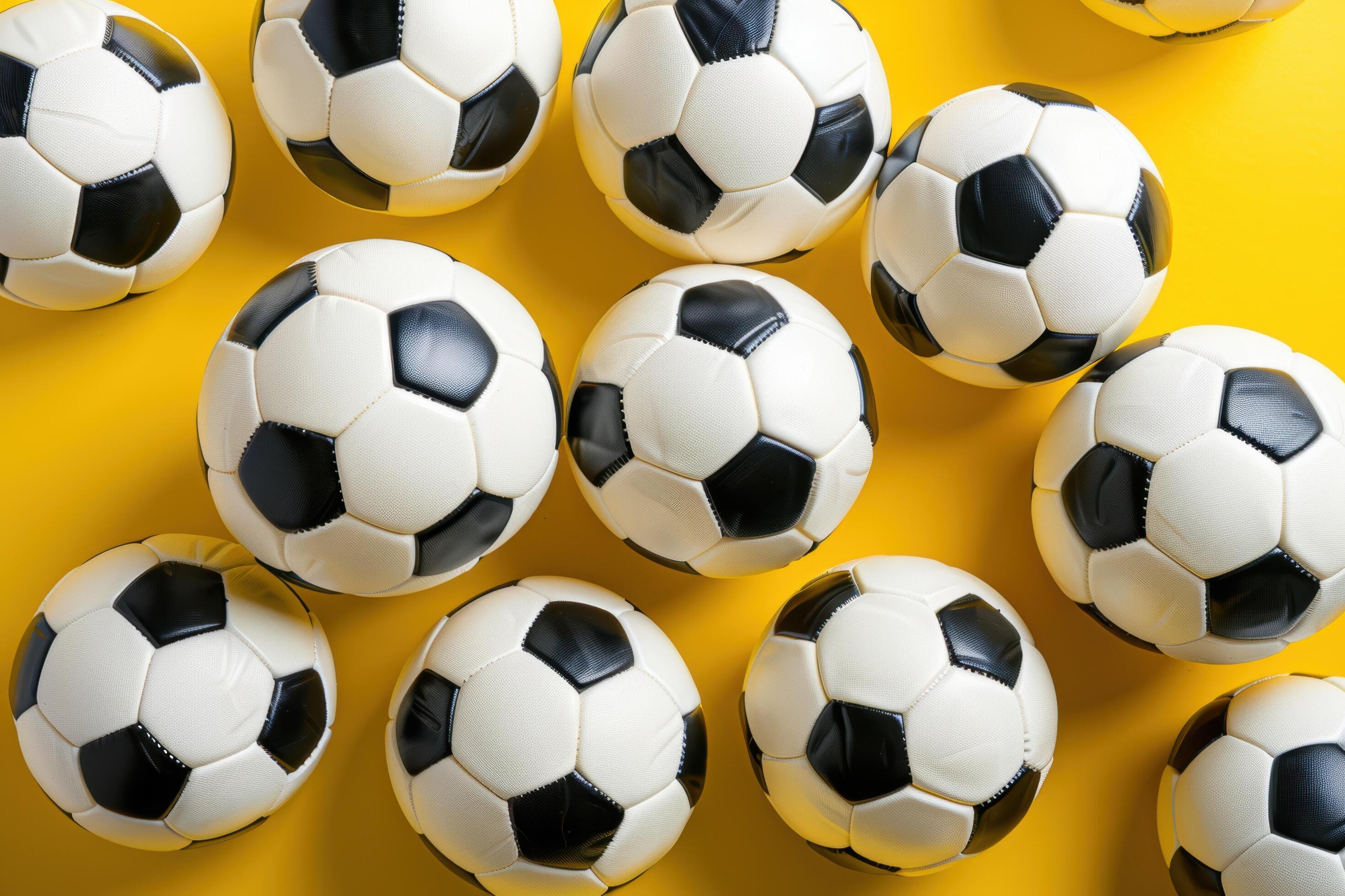 Multiple Soccer Balls Arranged on a Yellow Background Stock Free