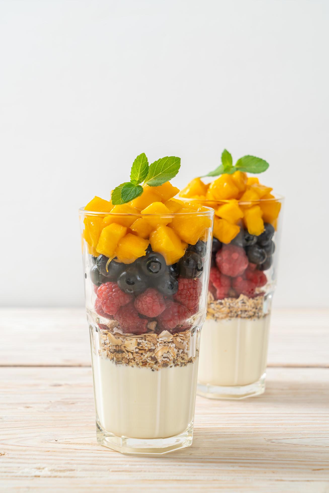 Homemade mango, raspberry, and blueberry with yogurt and granola – healthy food style Stock Free