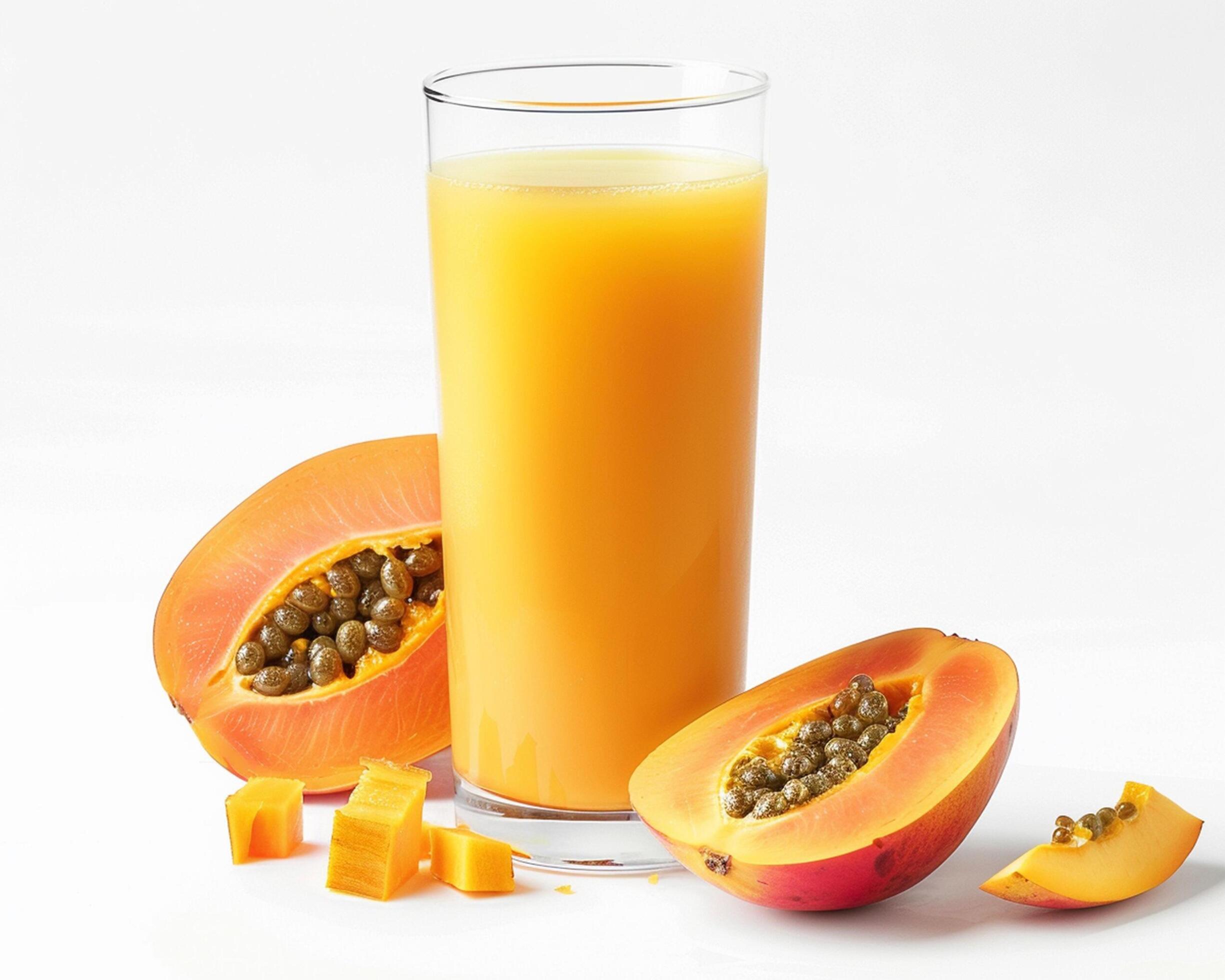 a glass of juice and a papaya Stock Free