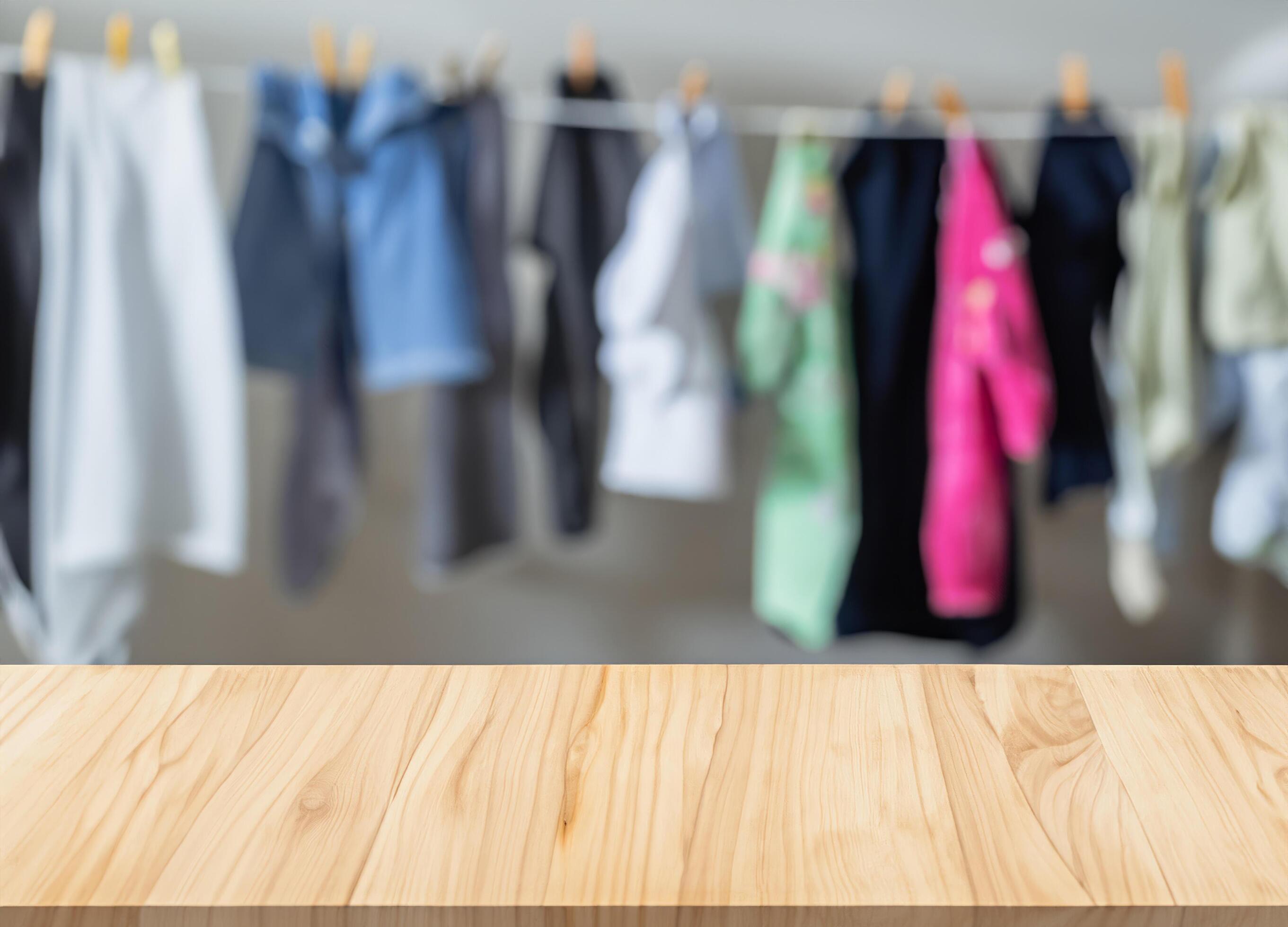 Wooden display table with blurred children’s clothes Stock Free