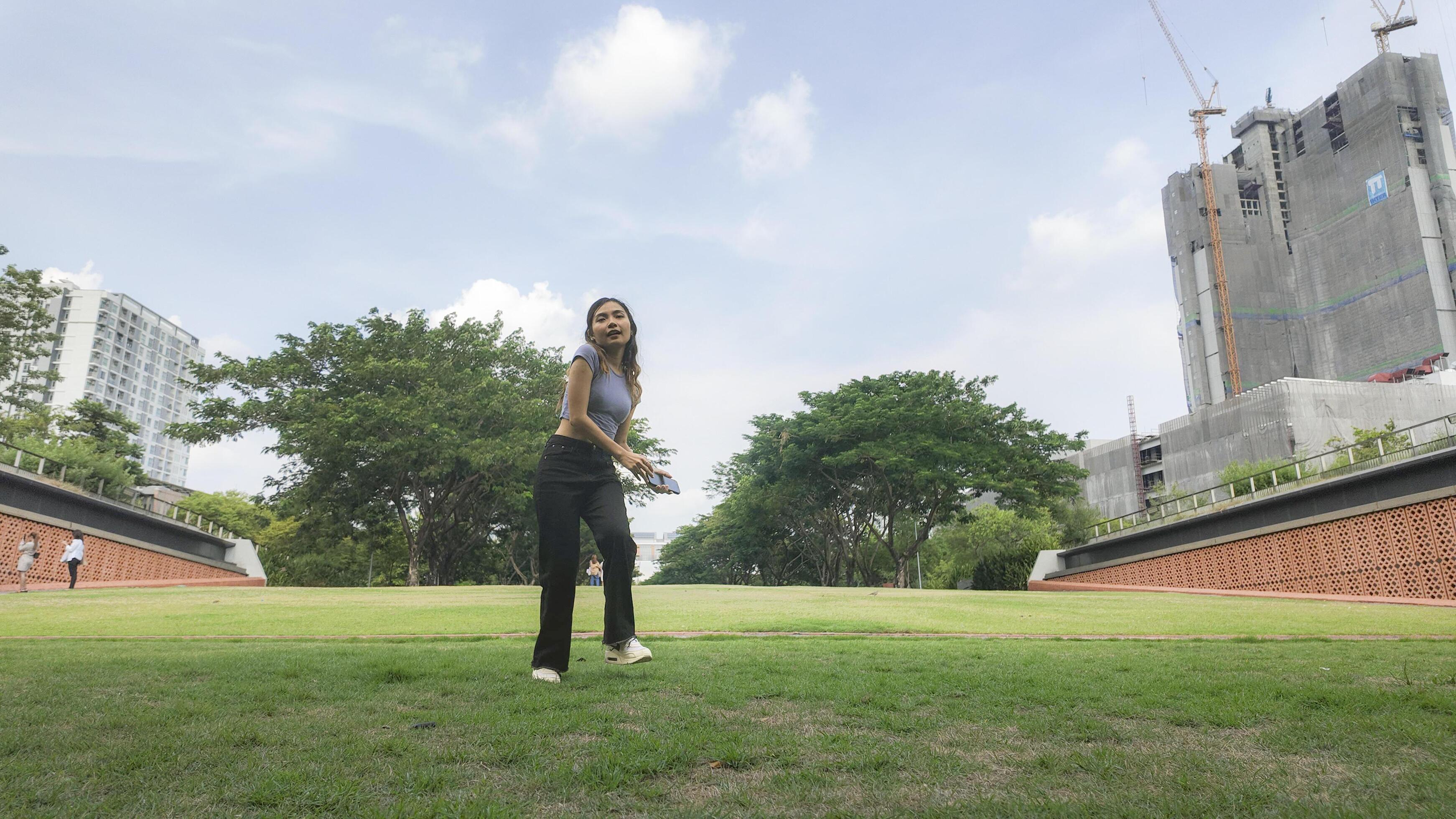 Asian women do freestyle hip hop and breakdancing in a public space in the middle of the city. With a cheerful and happy attitude Stock Free