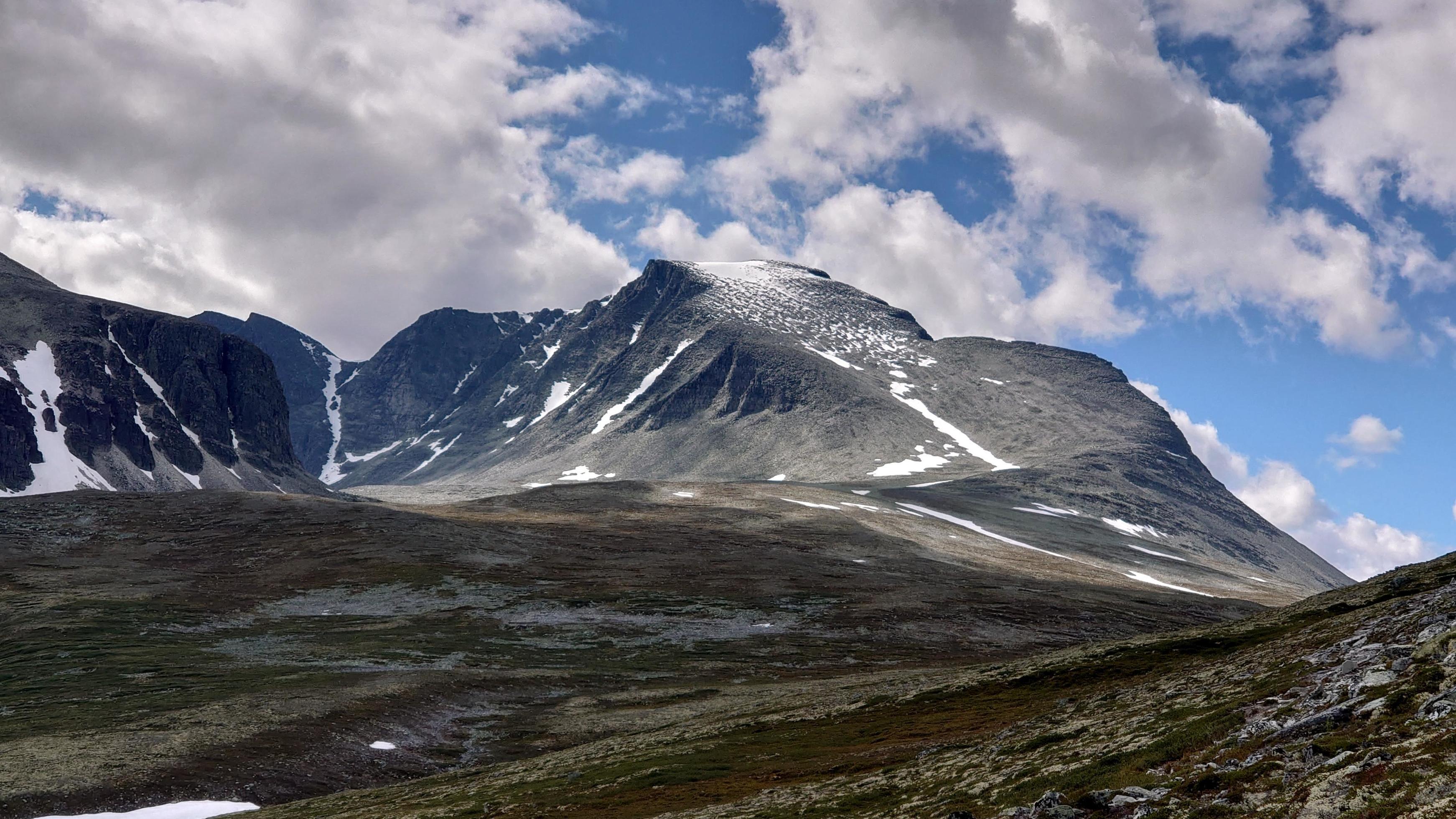 Snow-covered mountain under blue sky Stock Free