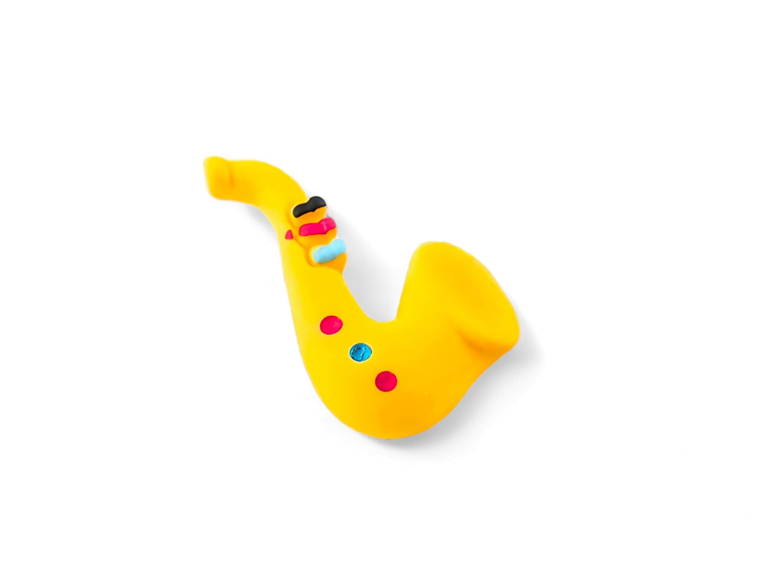 miniature saxophone musical instrument on a white background Stock Free