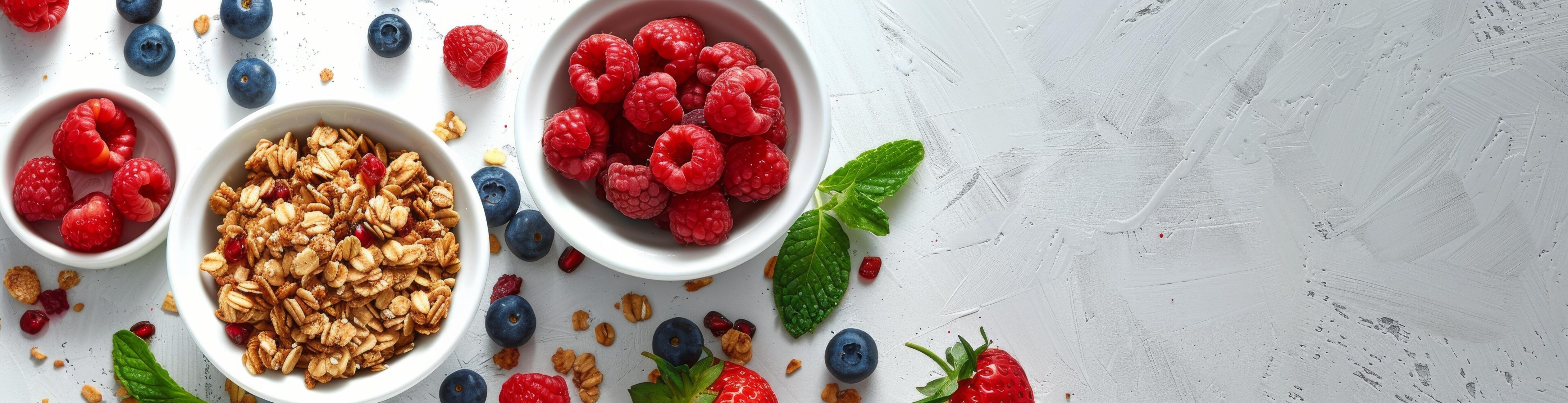 White Marble Surface With Bowls of Yogurt, Granola, and Raspberries Stock Free