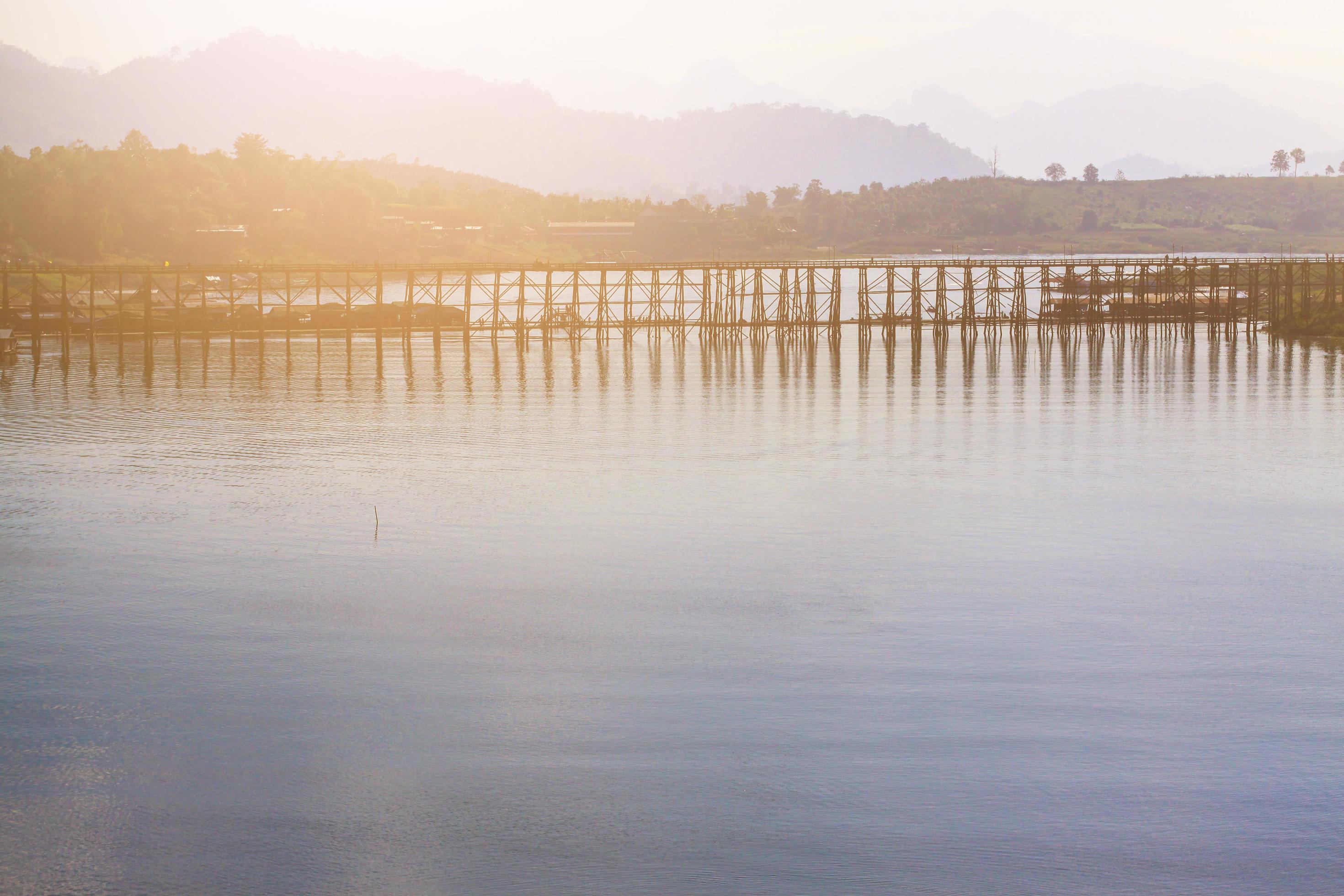 Beautiful sunrise on the Mon wooden Bridge with blue sky in sangkhlaburi, Thailand Stock Free