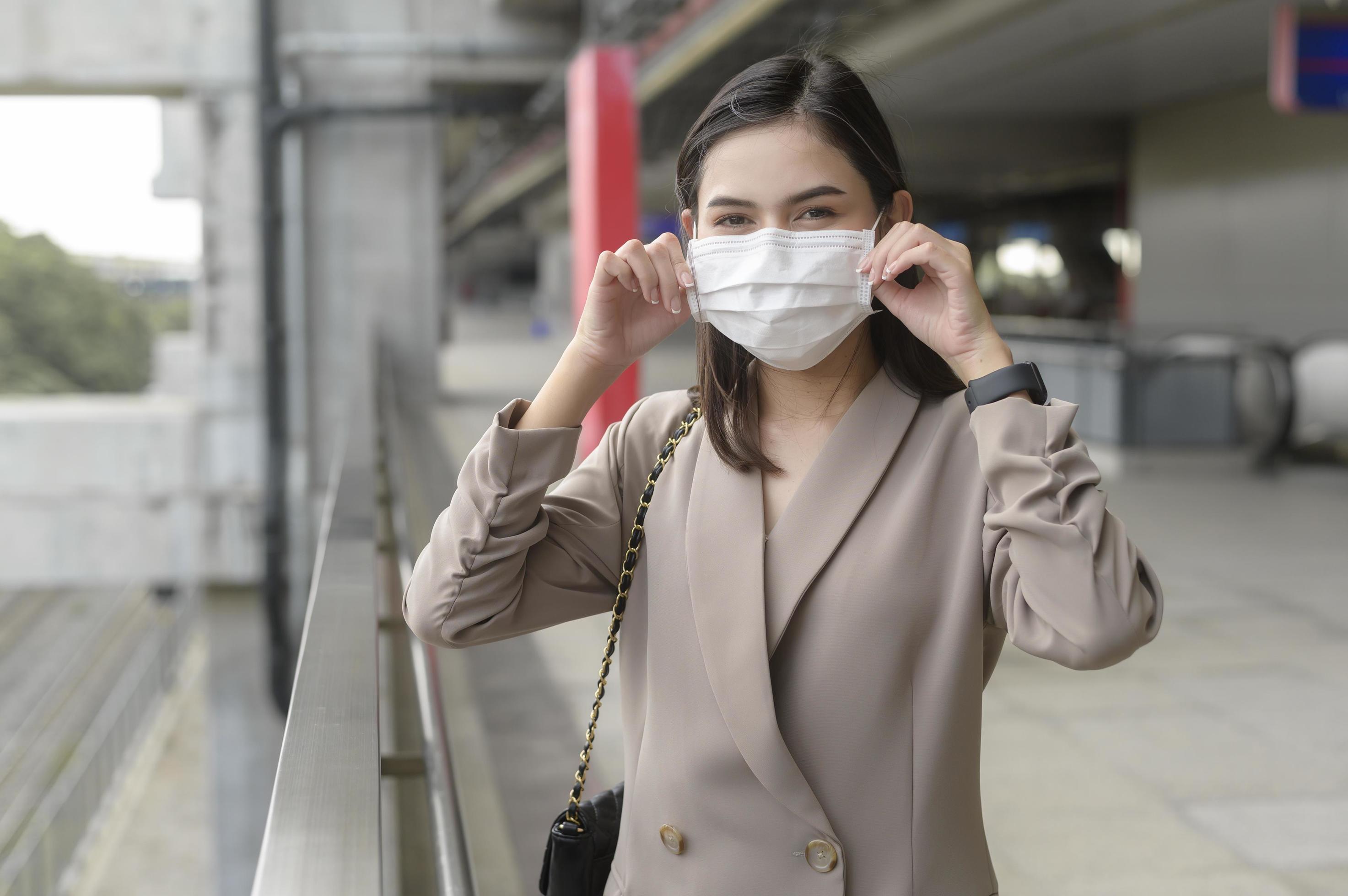 A portrait of Businesswoman is wearing face mask work in modern City , people lifestyle , working under Covid-19 pandemic concept Stock Free