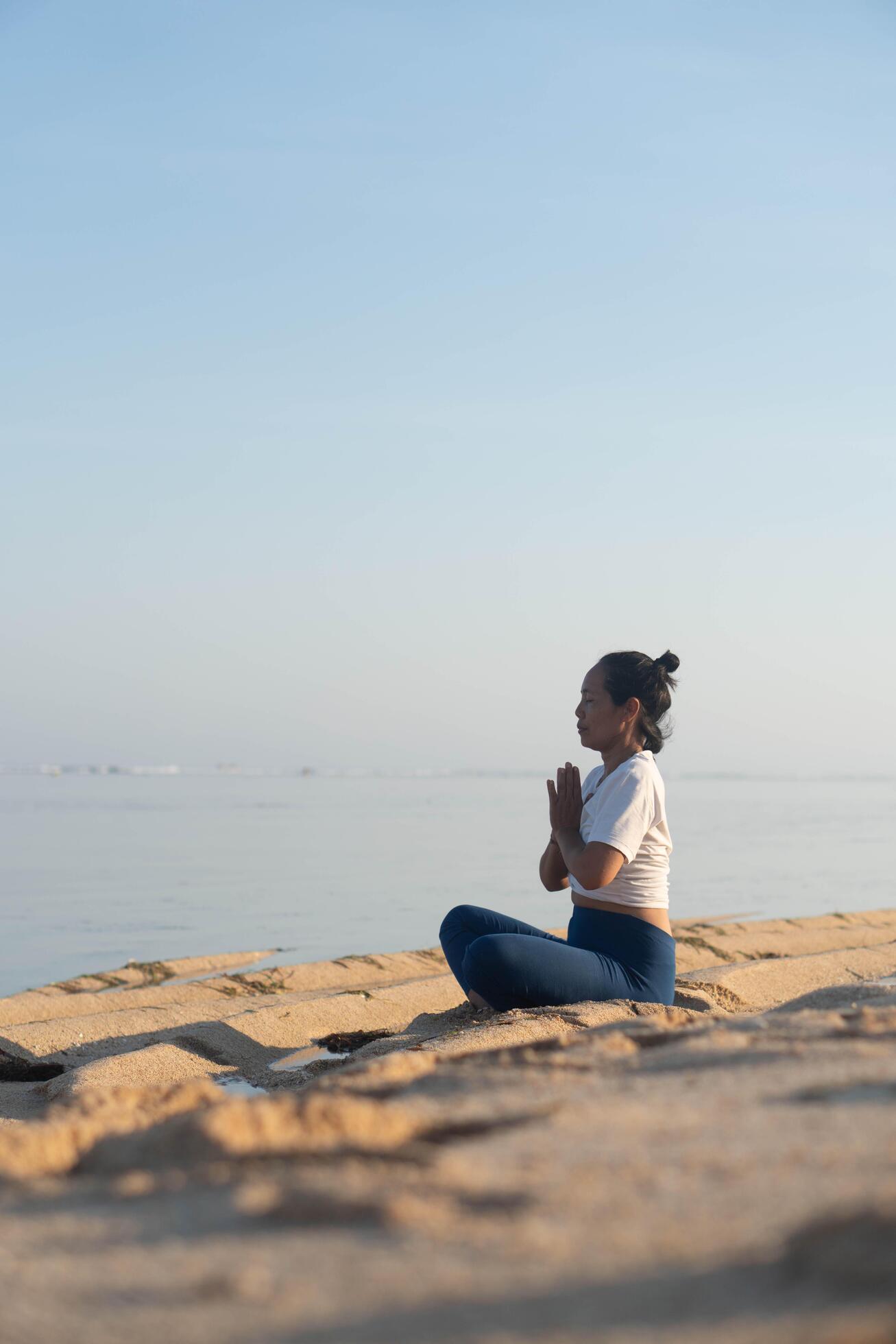 healthy woman with beautiful body doing yoga at sunrise on the beach, yoga poses Stock Free