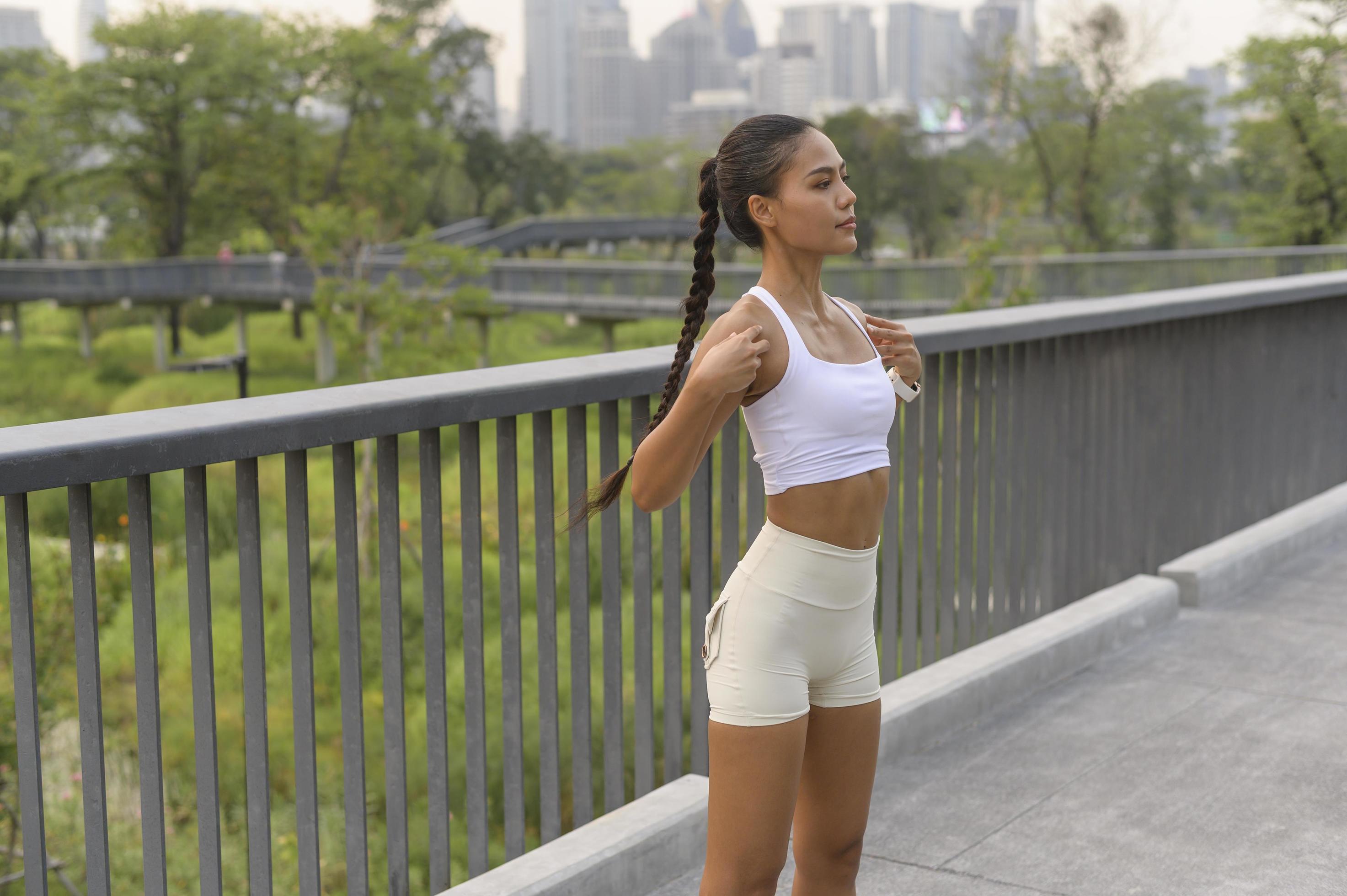 A young fitness woman in sportswear exercising in city park, Healthy and Lifestyles. Stock Free