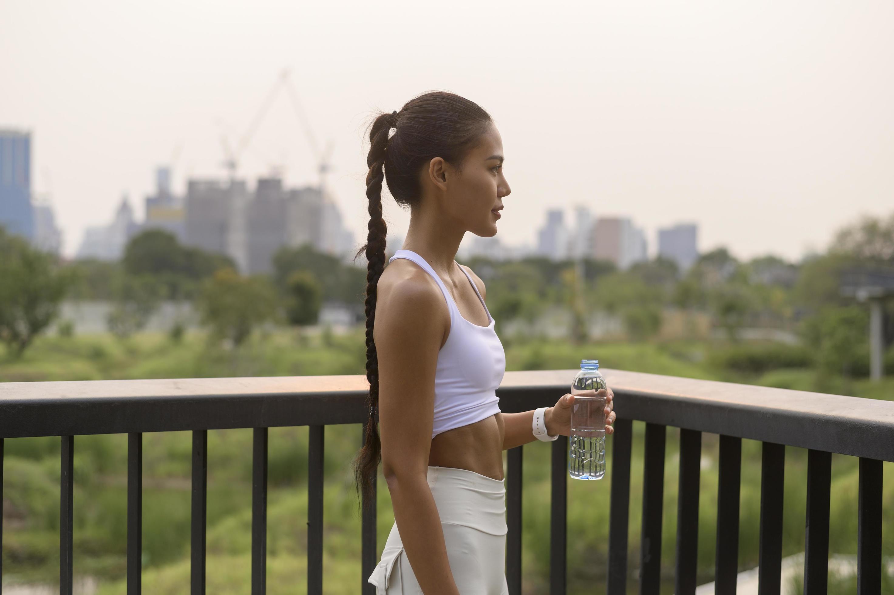 Young fitness woman in sportswear drinking water in city park, Healthy and Lifestyles. Stock Free