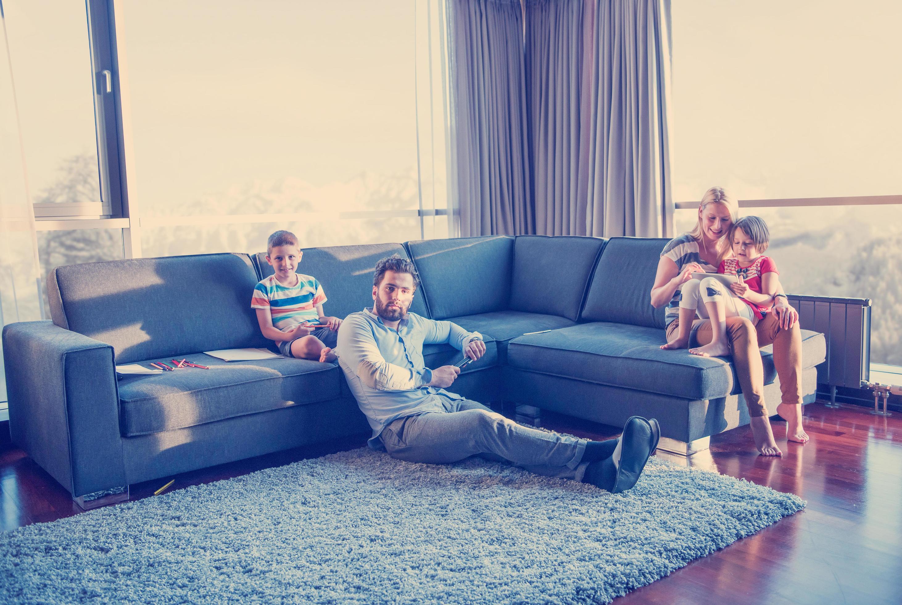 Happy Young Family Playing Together on sofa Stock Free