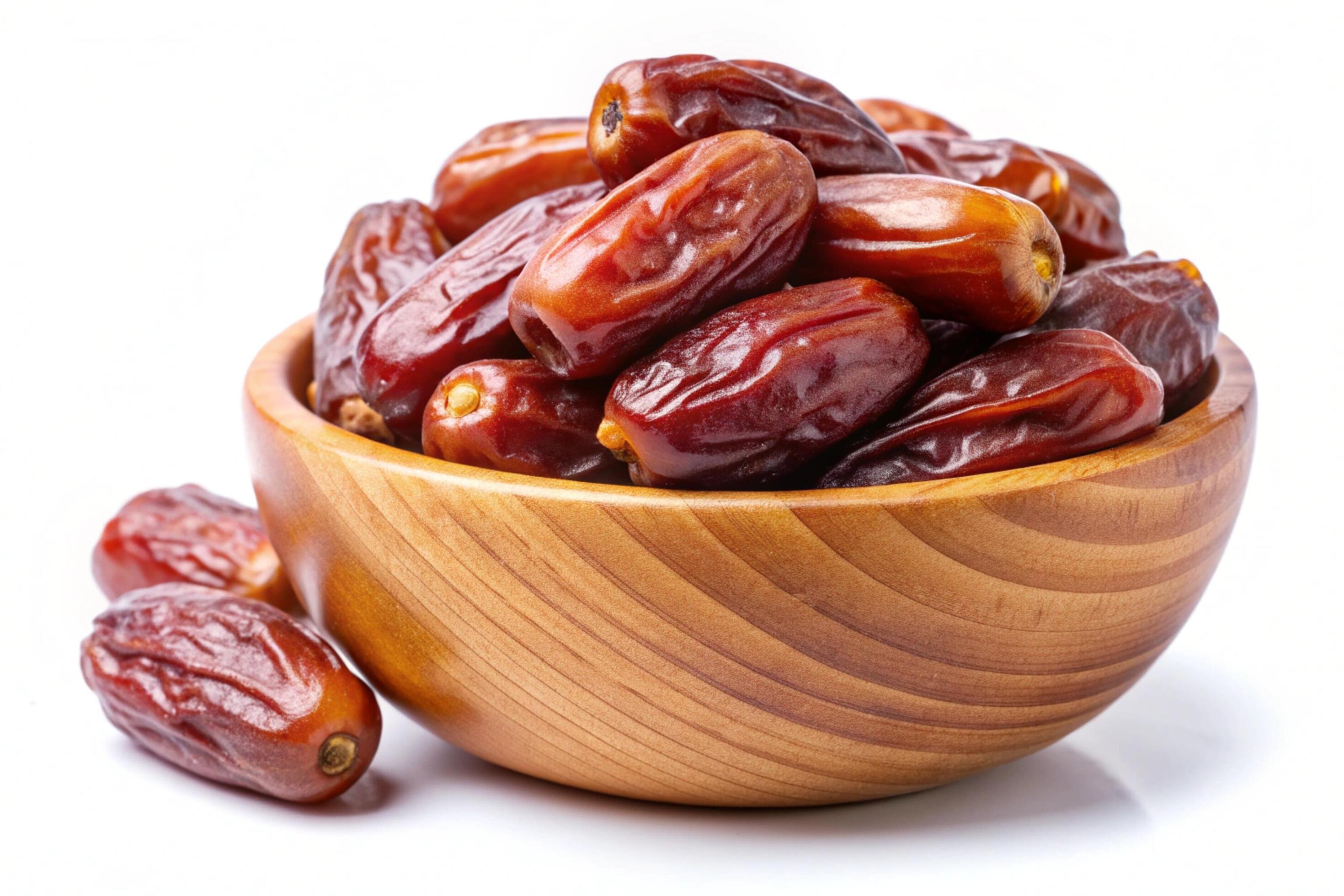 Dates in wood bowl isolated on white background Stock Free