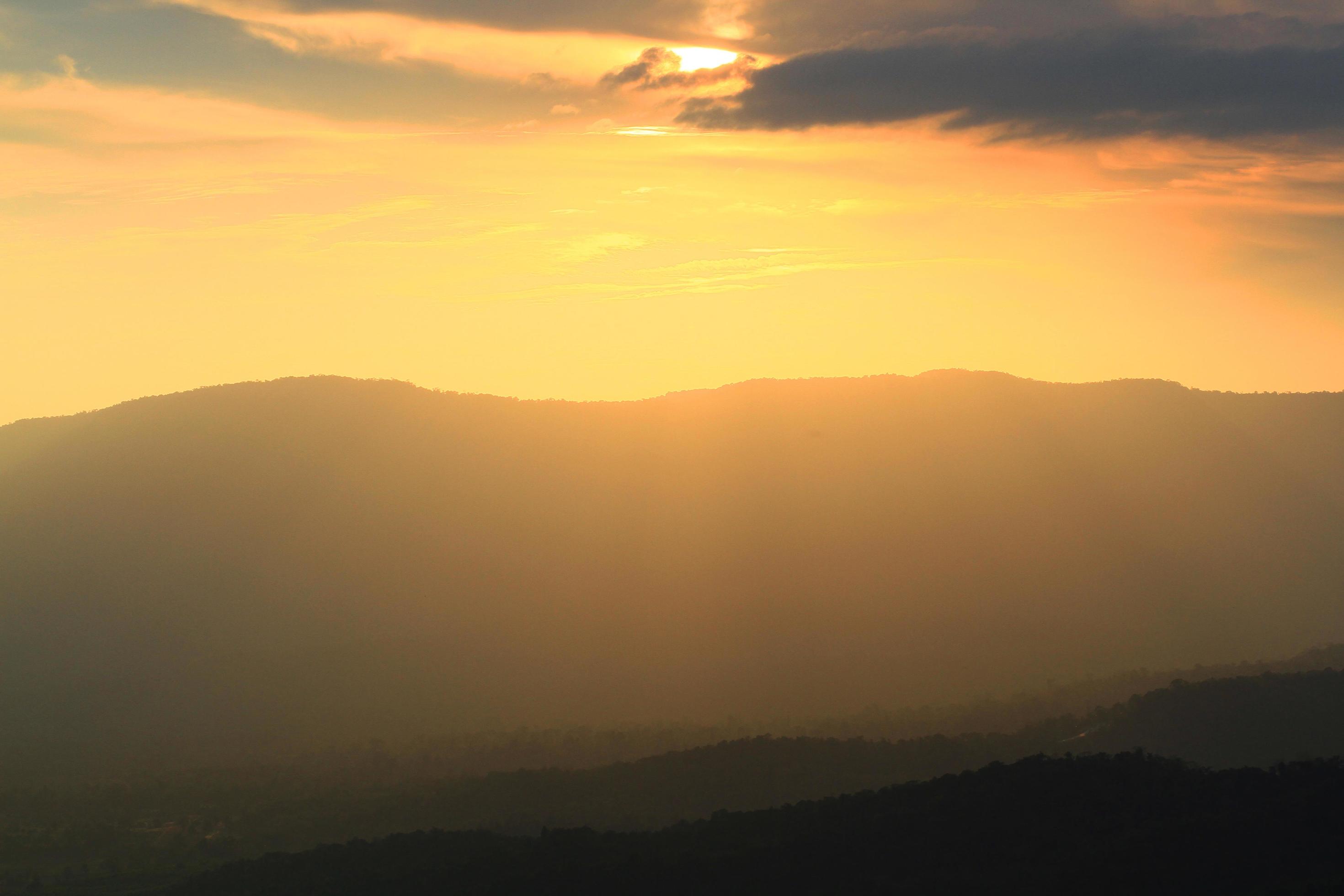 Beautiful landscape layers of mountain and Misty on hill valley in golden twilight of sunset at Thailand Stock Free