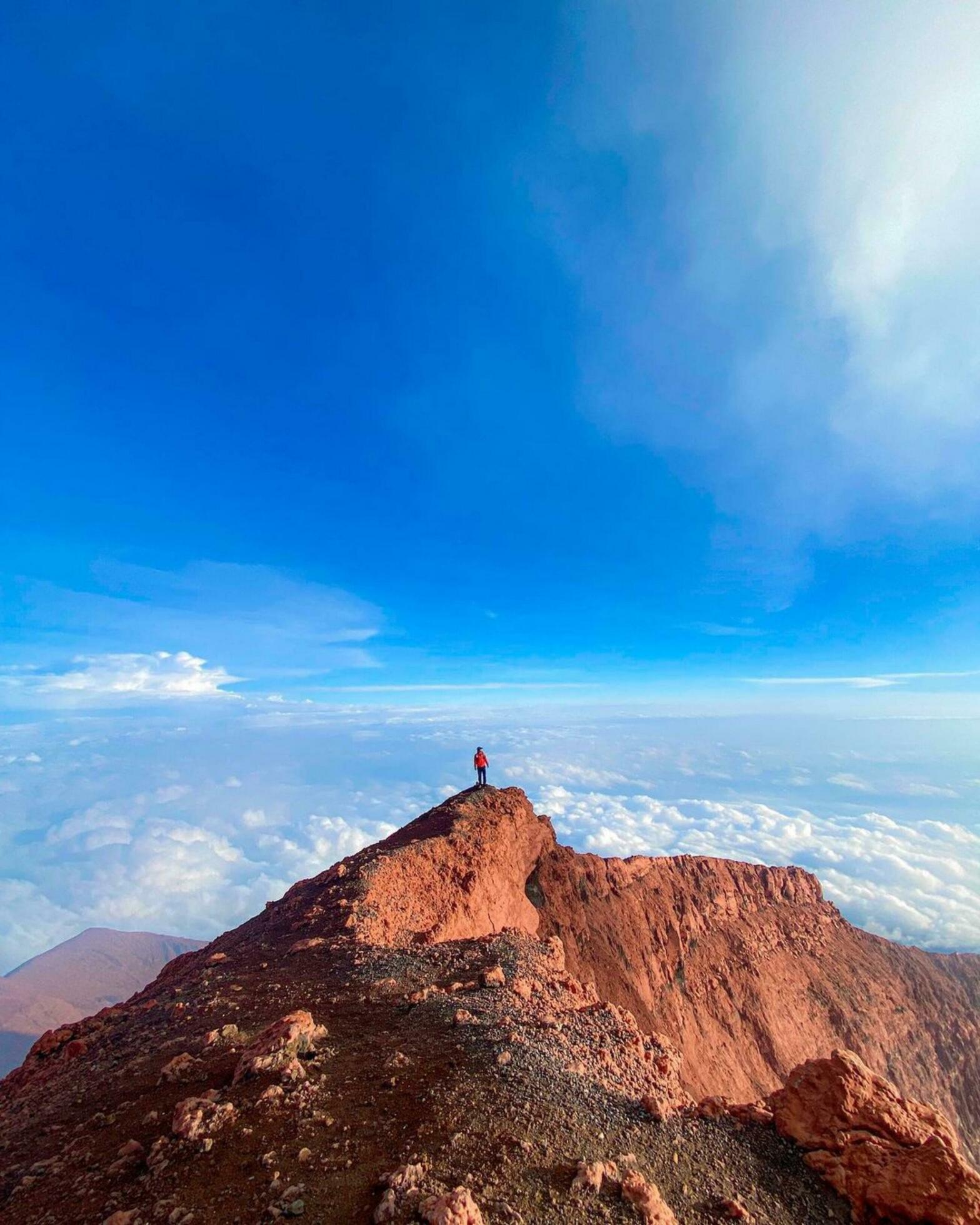 Tranquil Horizon Serene Adventure in Azure Wilderness Adventure seeker finds serenity in nature’s beauty under a vast blue sky. Stock Free