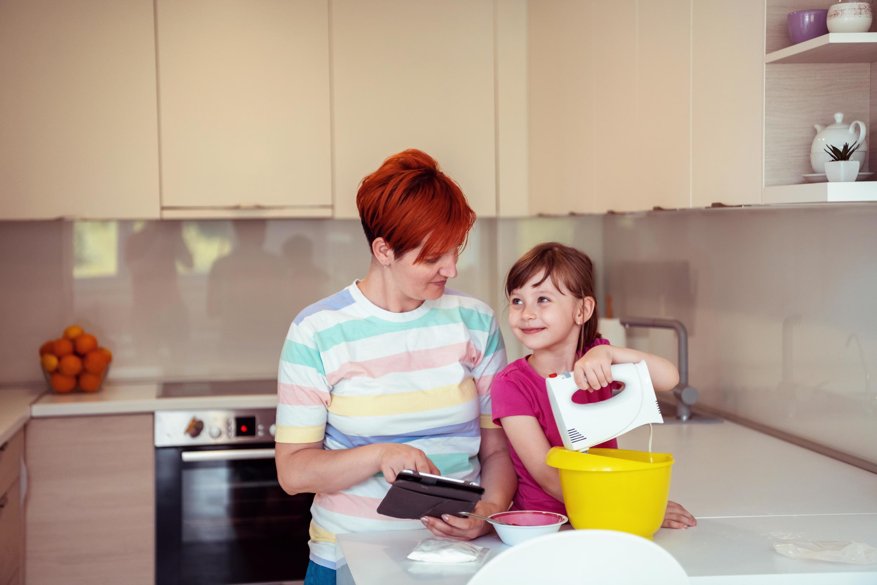 little girl and mom making tastz cake in kithen family having fun at home Stock Free