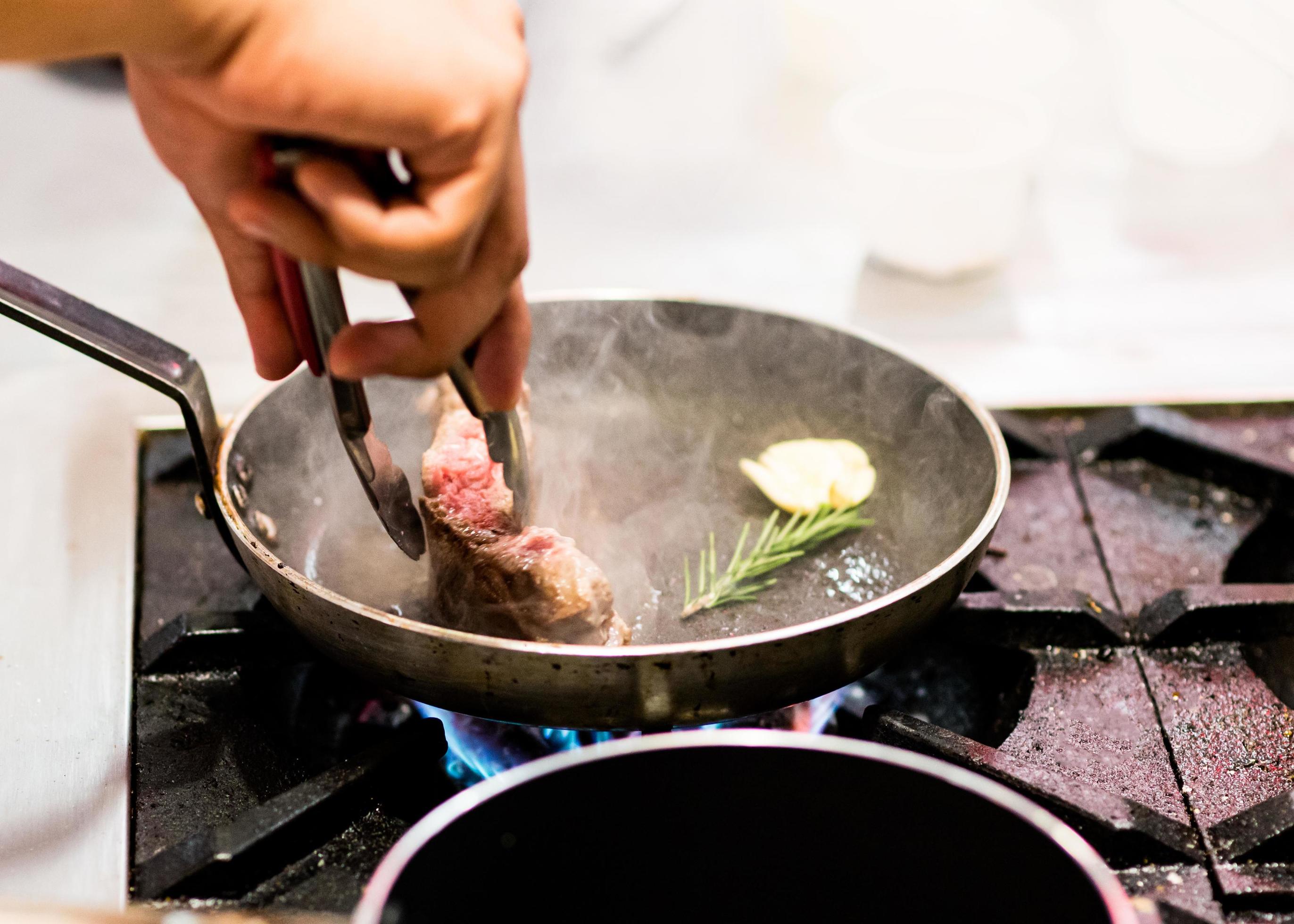 Chef cooking, Chef preparing food in the kitchen, closeup Stock Free