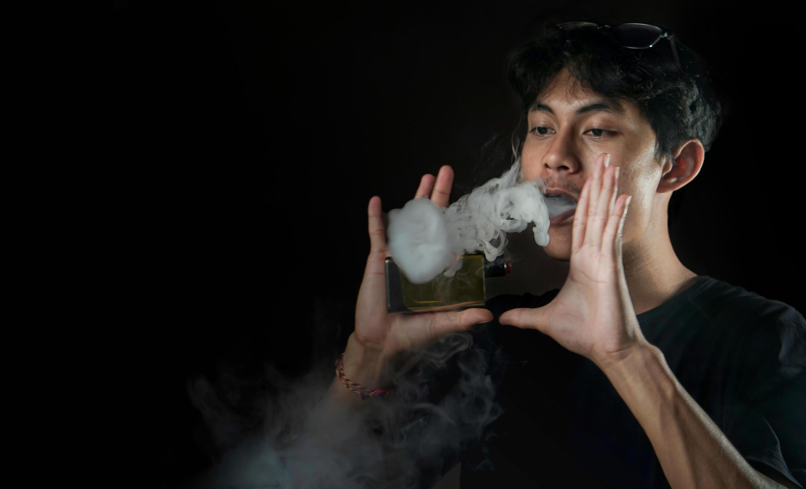 
									Man making smoke ring with vapor Stock Free