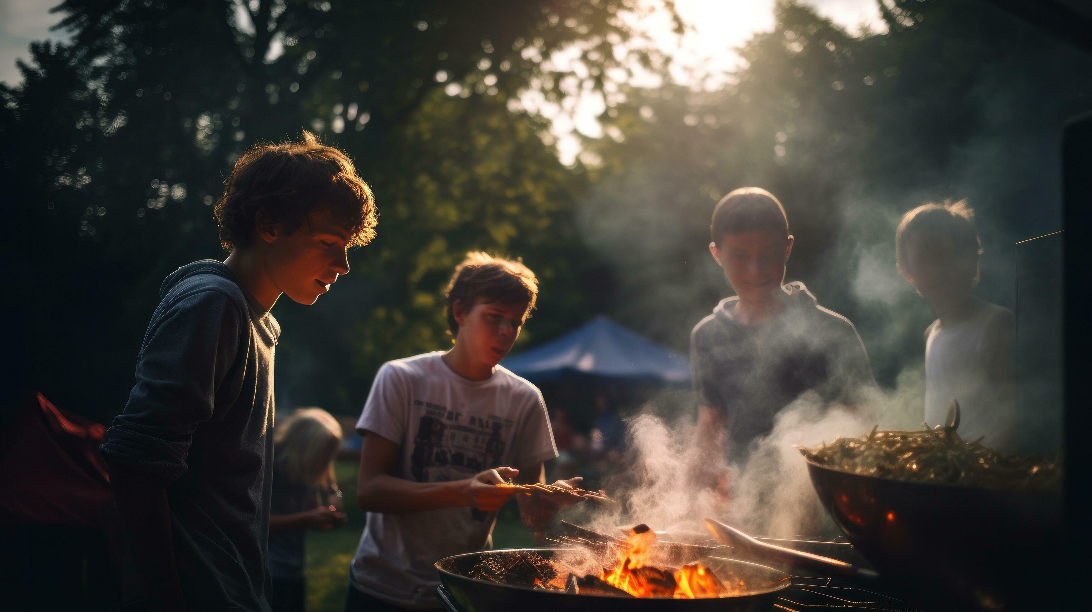 Young family is grilling at the barbecue Stock Free