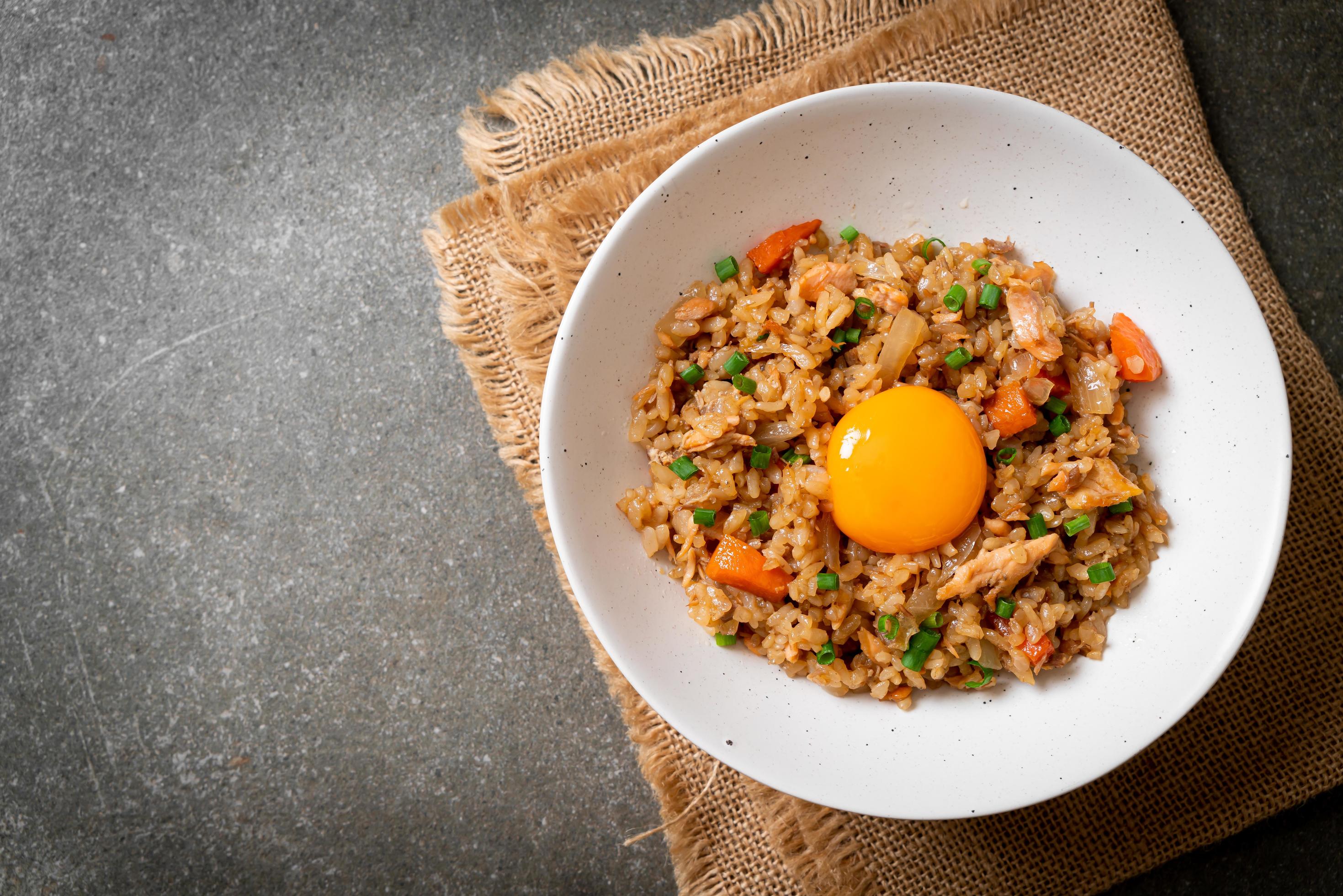 Salmon fried rice with pickled egg on top – Asian food style Stock Free