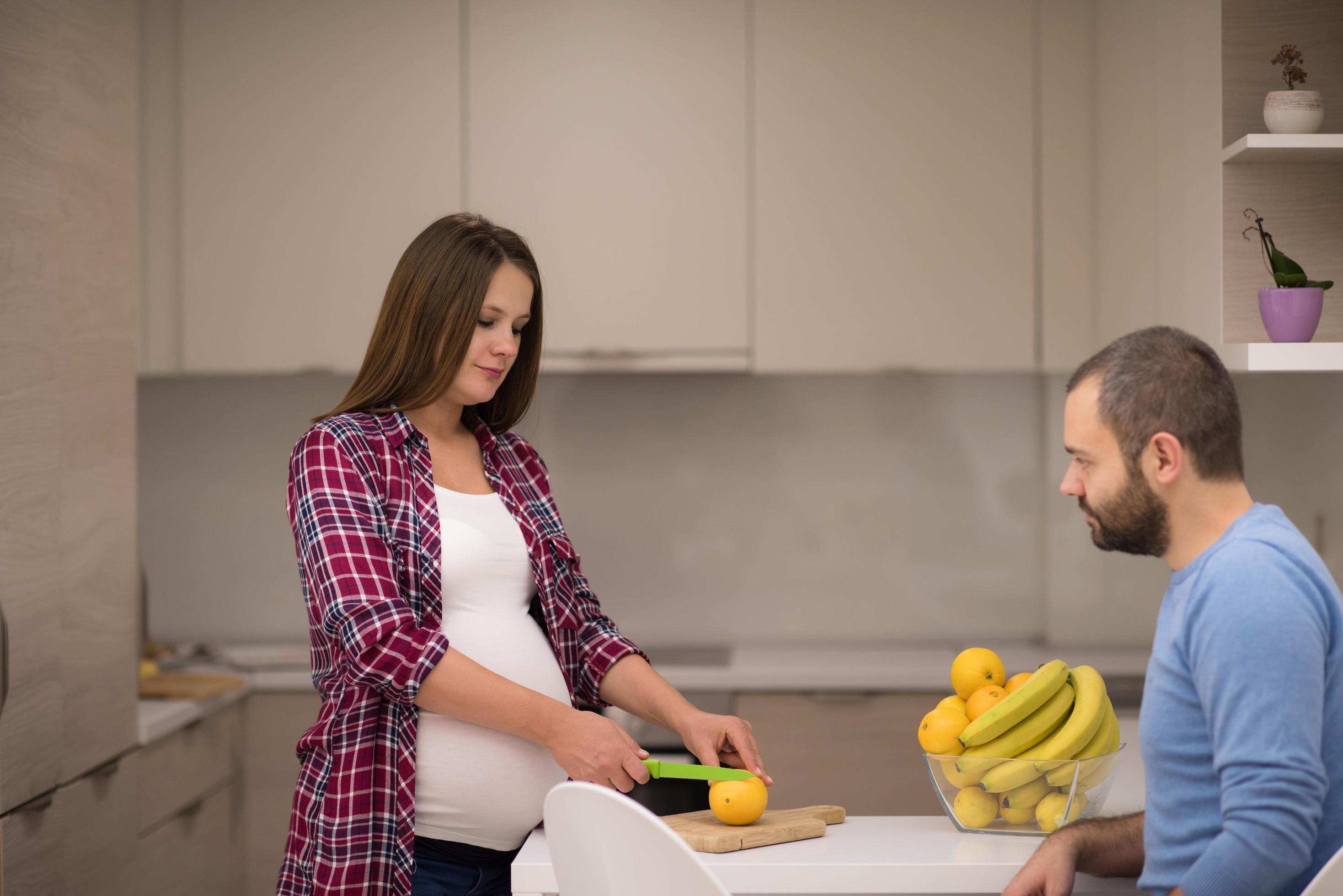 couple cooking food fruit lemon juice at kitchen Stock Free