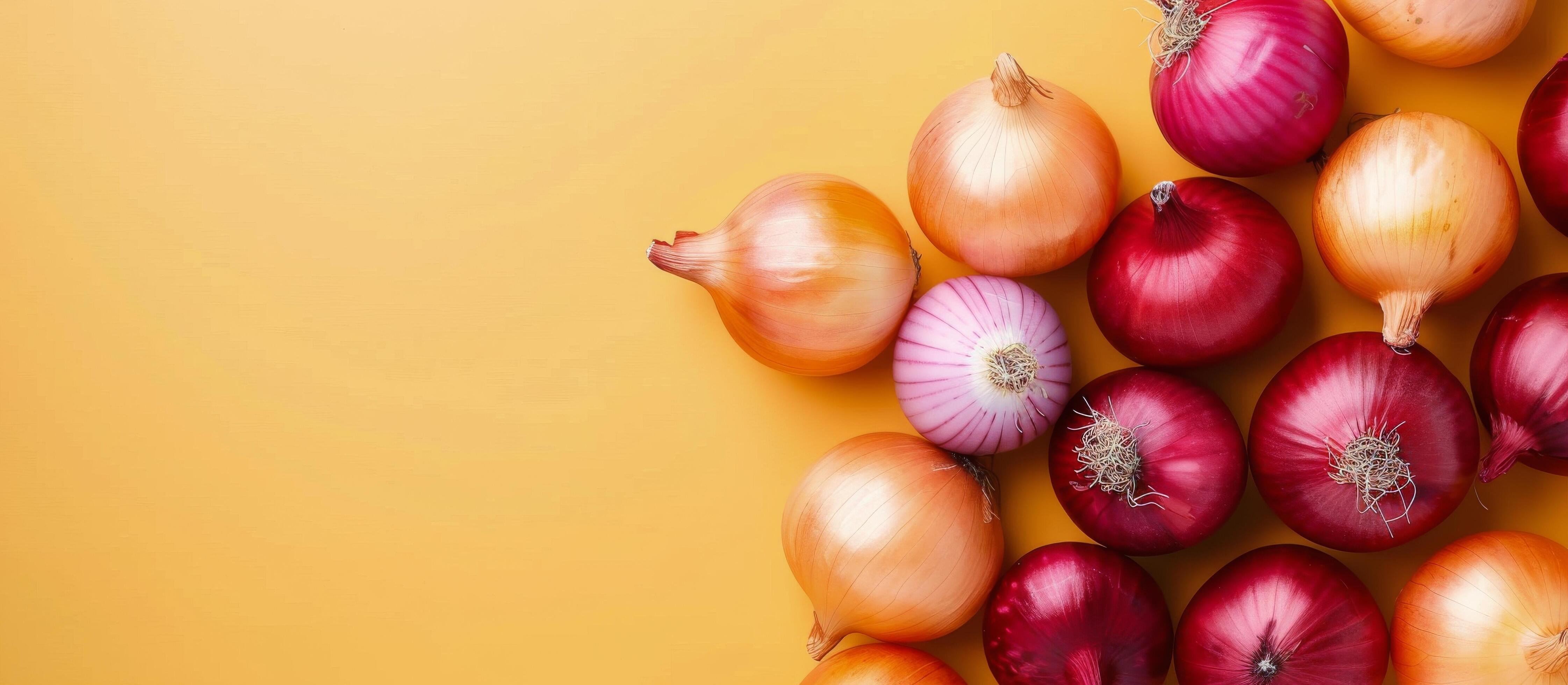 Variety of Fresh Onions on Yellow Background Stock Free