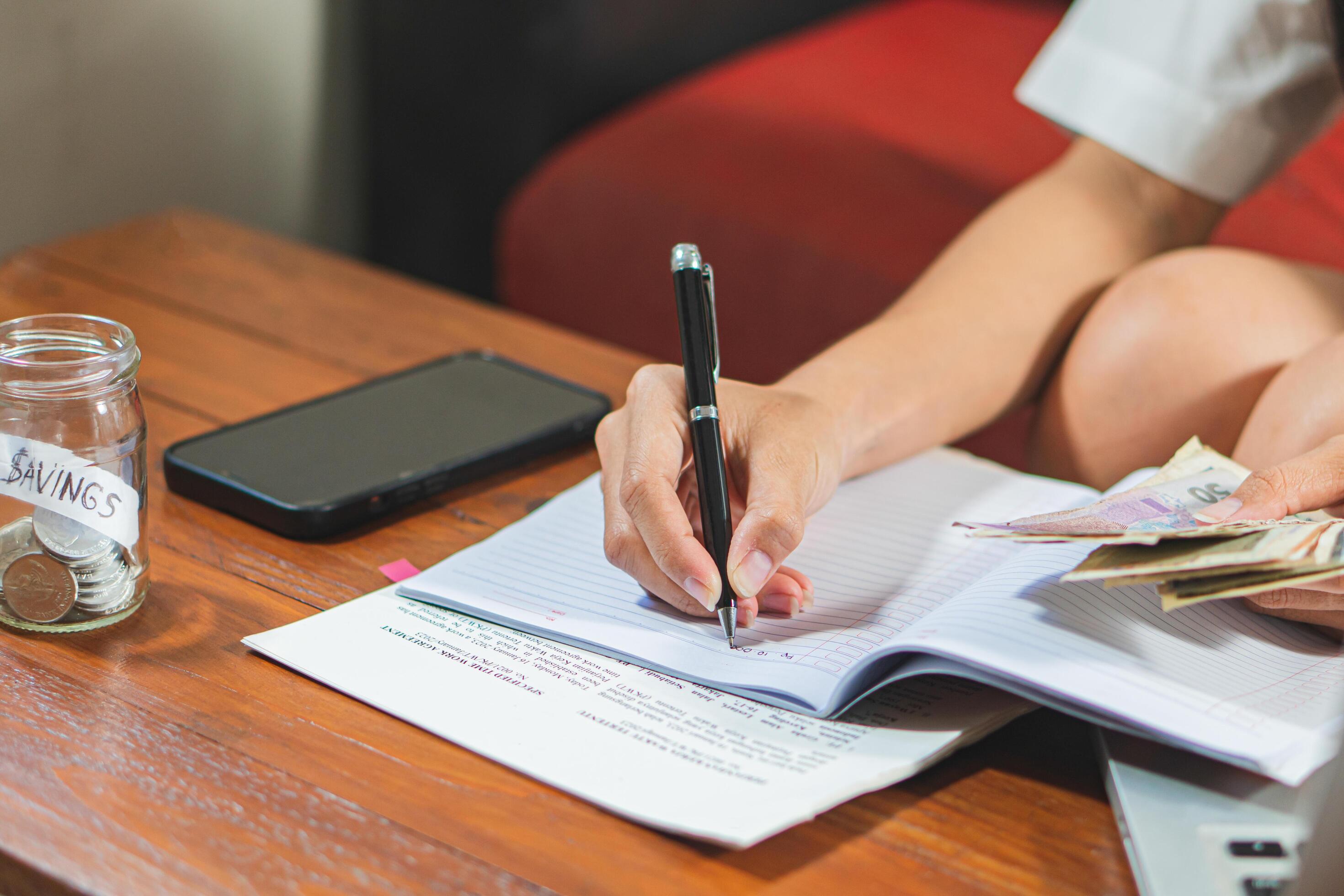 Young woman checking bills, taxes, bank account balance and calculating credit card expenses Stock Free